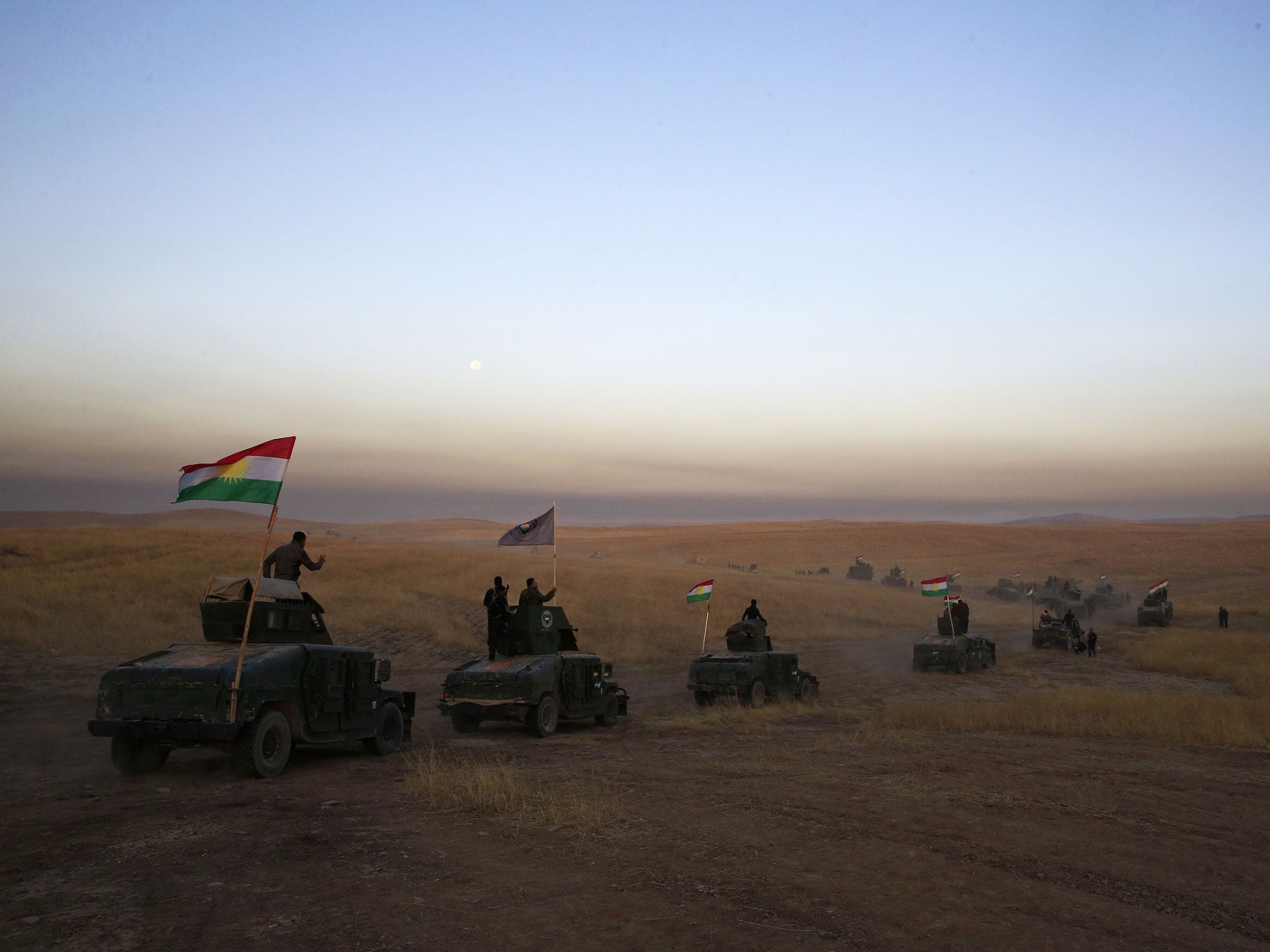 A Kurdish Peshmerga convoy drives towards the front line in Khazer, about 20 miles east of Mosul