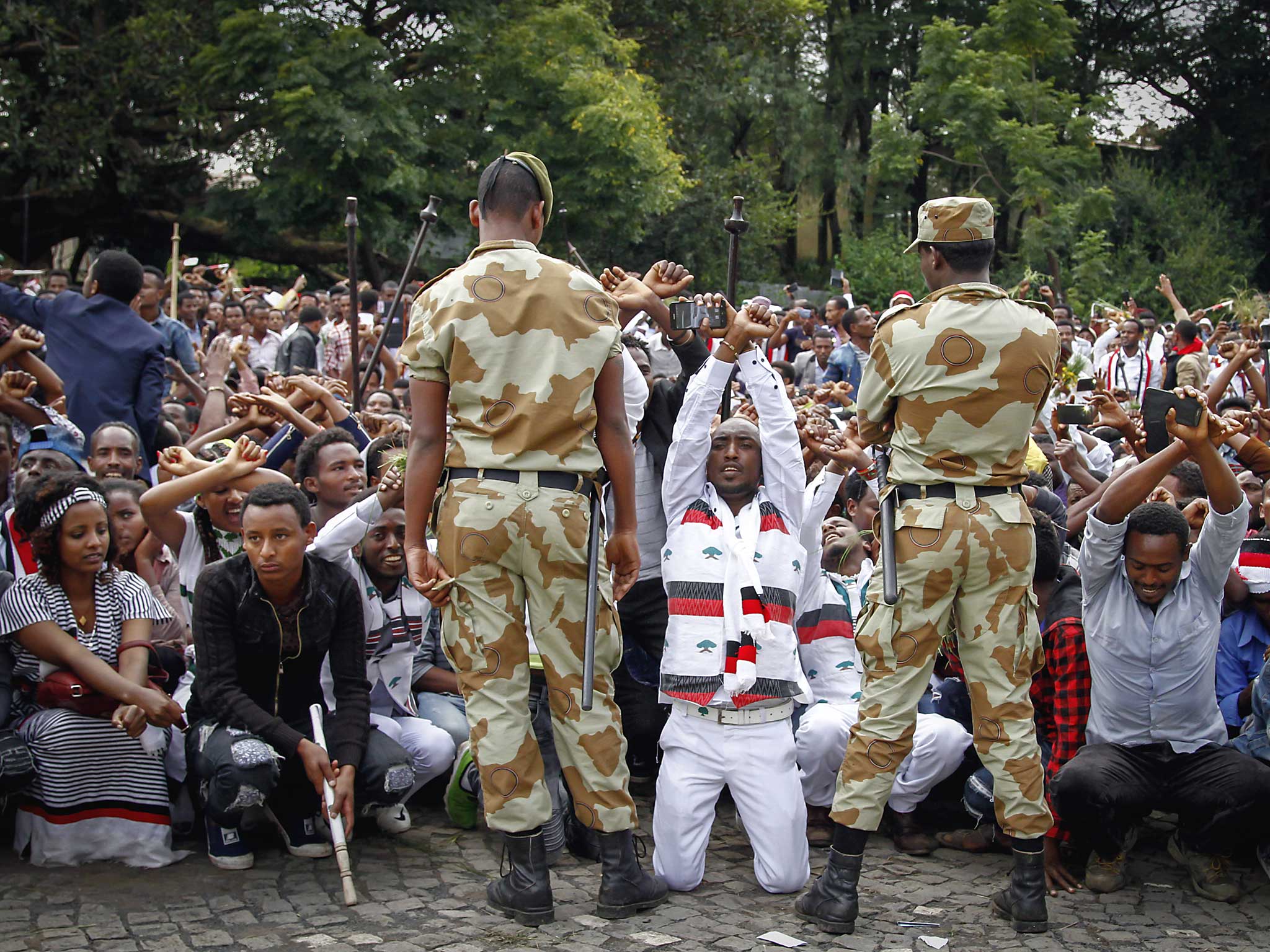 Ethiopian soldiers try to stop protesters in Bishoftu, in the Oromia region of Ethiopia