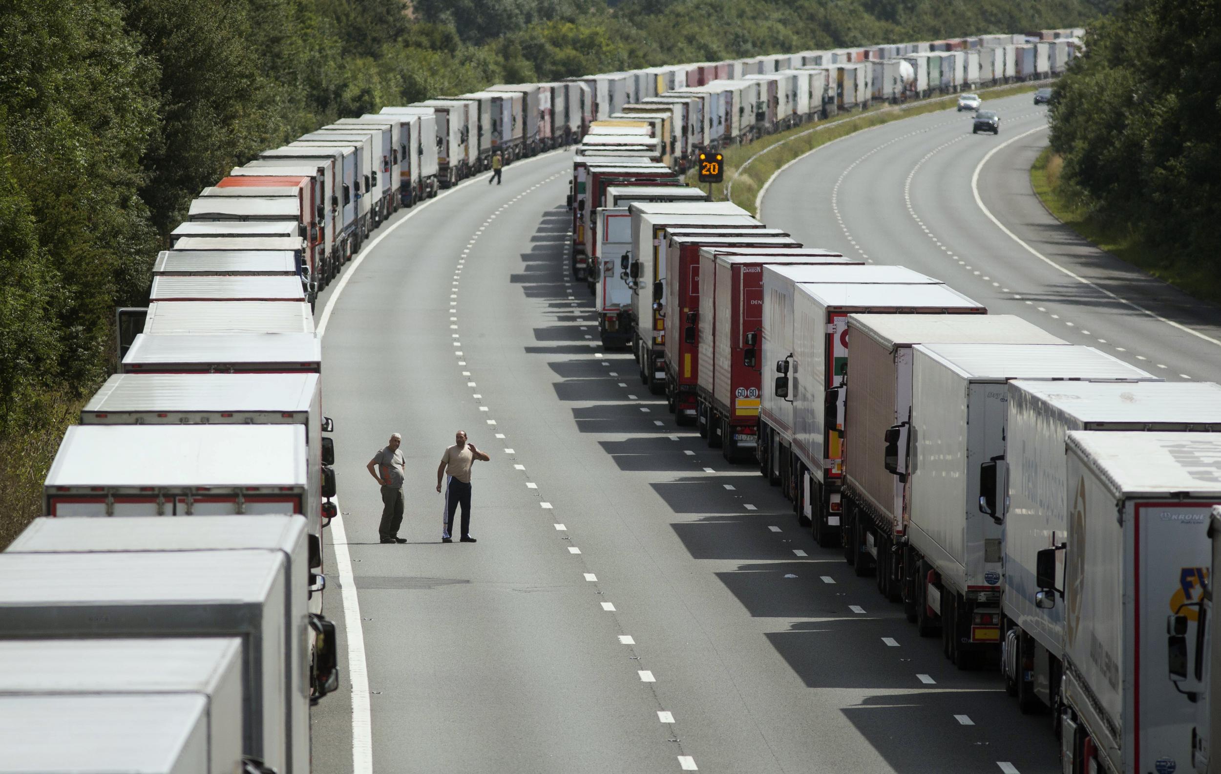 Drivers wait next to their parked lorries on the M20 motorway as part of Operation Stack, which aims to manage traffic during disruption to Eurotunnel or ferry services (REUTERS/Neil Hall)