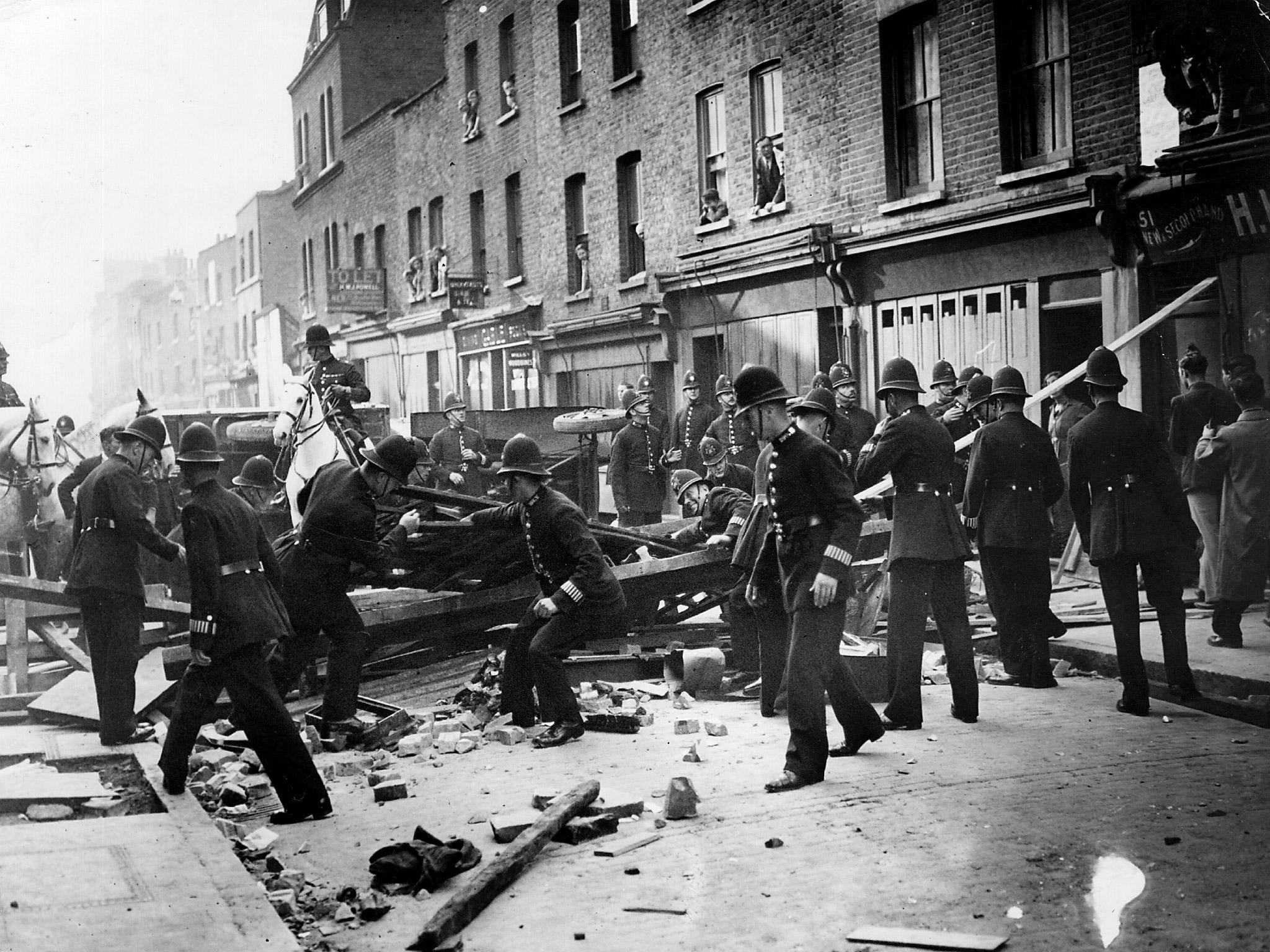 British policemen dismantle a barrier near Mark Lane, London, to make way for a march by supporters of the leader of the British Union of Fascists Oswald Mosley. The barricade was constructed by members of the Communist Party during the Battle of Cable Street