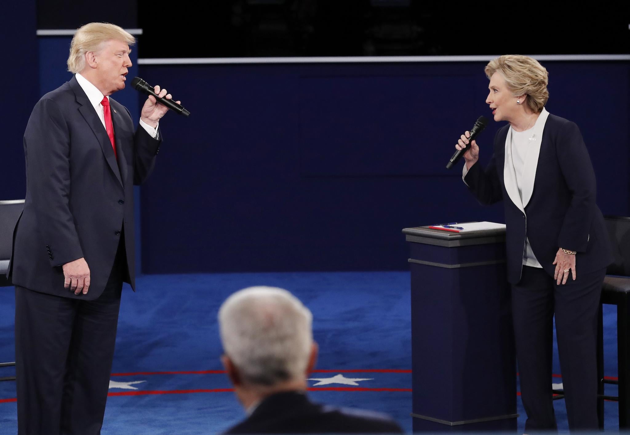 Republican U.S. presidential nominee Donald Trump and Democratic U.S. presidential nominee Hillary Clinton speak during their presidential town hall debate at Washington University in St. Louis