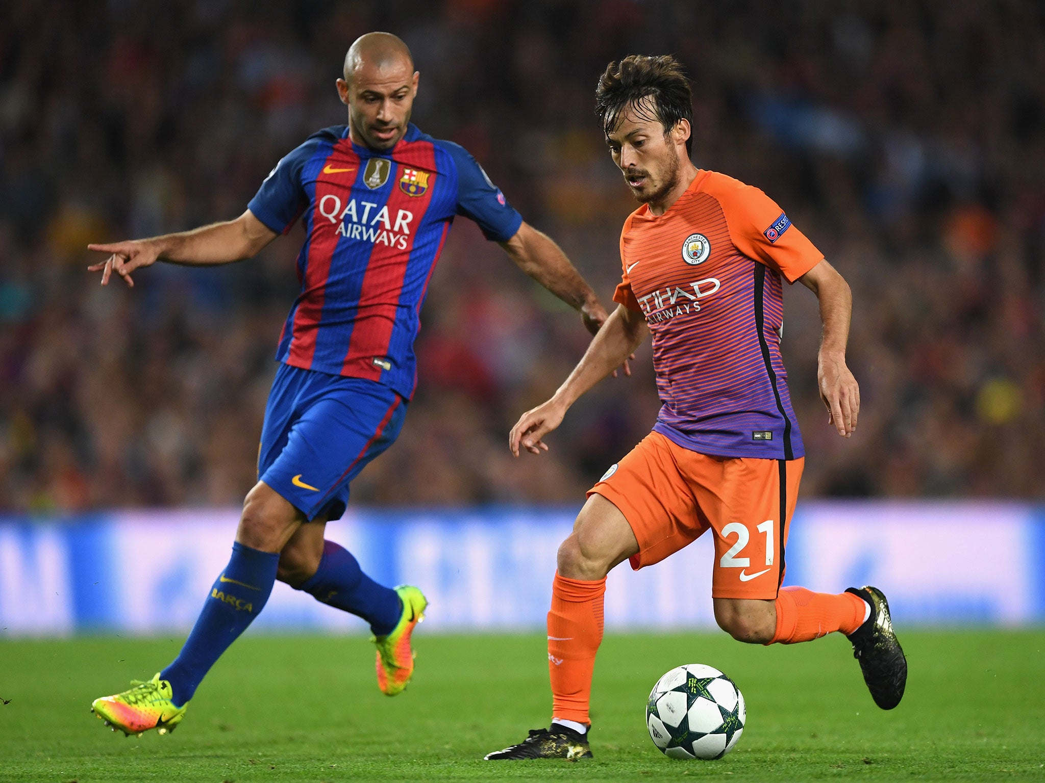 David Silva attempts to get away from Barcelona's Javier Mascherano