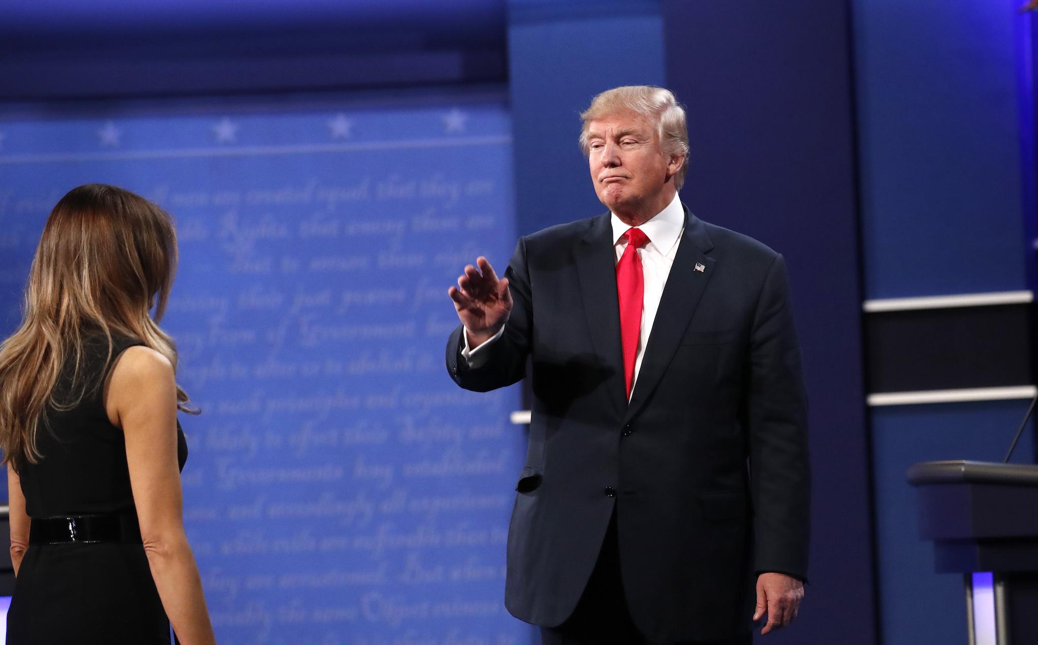 Republican U.S. presidential nominee Donald Trump waves as he is greeted by his wife Melania (L) after the conclusion of the third and final debate with Democratic nominee Hillary Clinton at UNLV in Las Vegas, Nevada