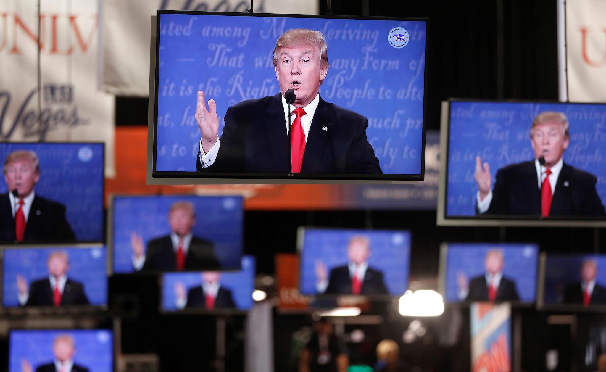 Republican U.S presidential nominee Donald Trump is shown on TV monitors in the media filing room on the campus of University of Nevada