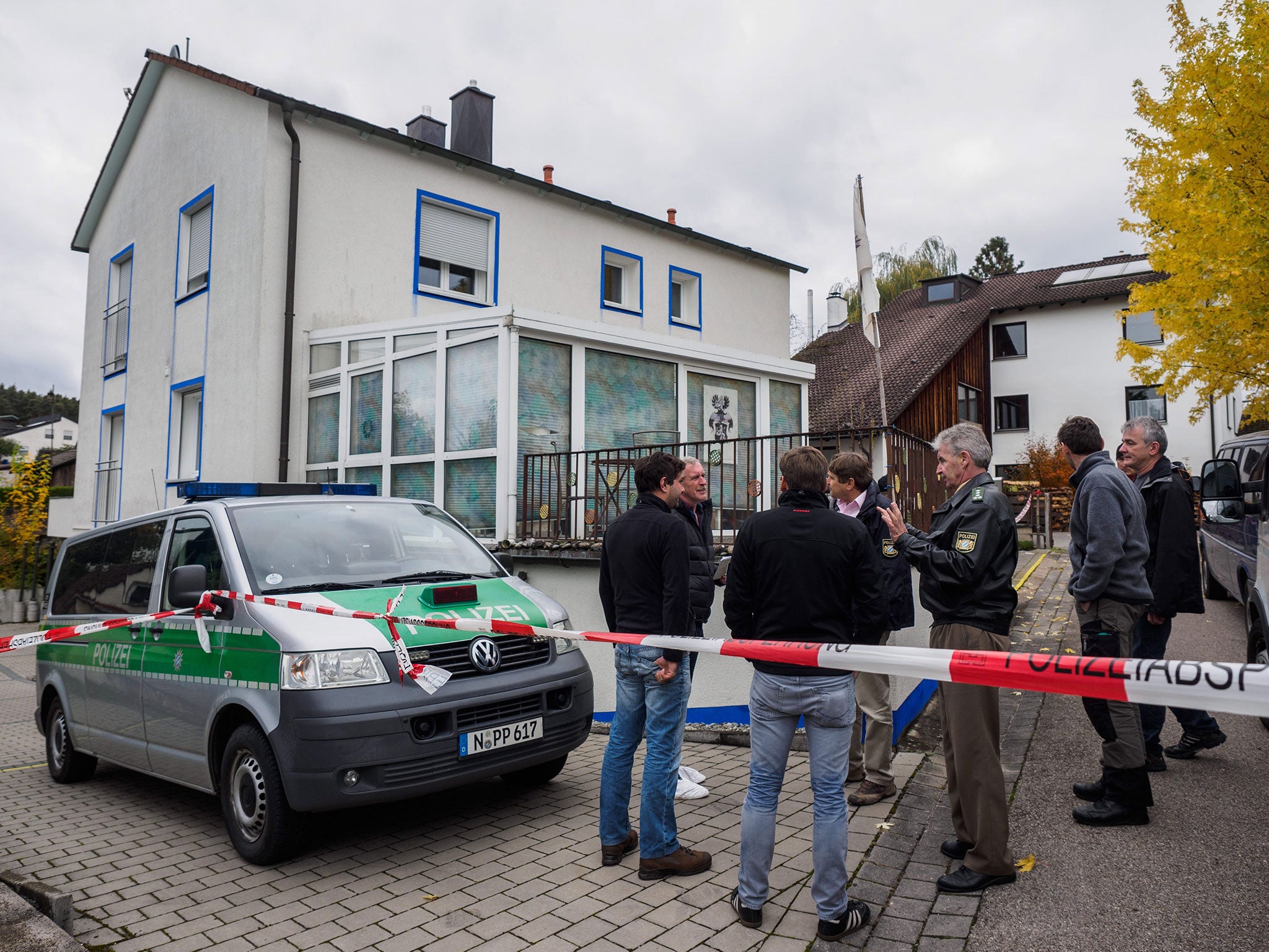 Police officers gather in front of a house where a man opened fire on police in Georgensgmuend, Germany, 19 October 2016.