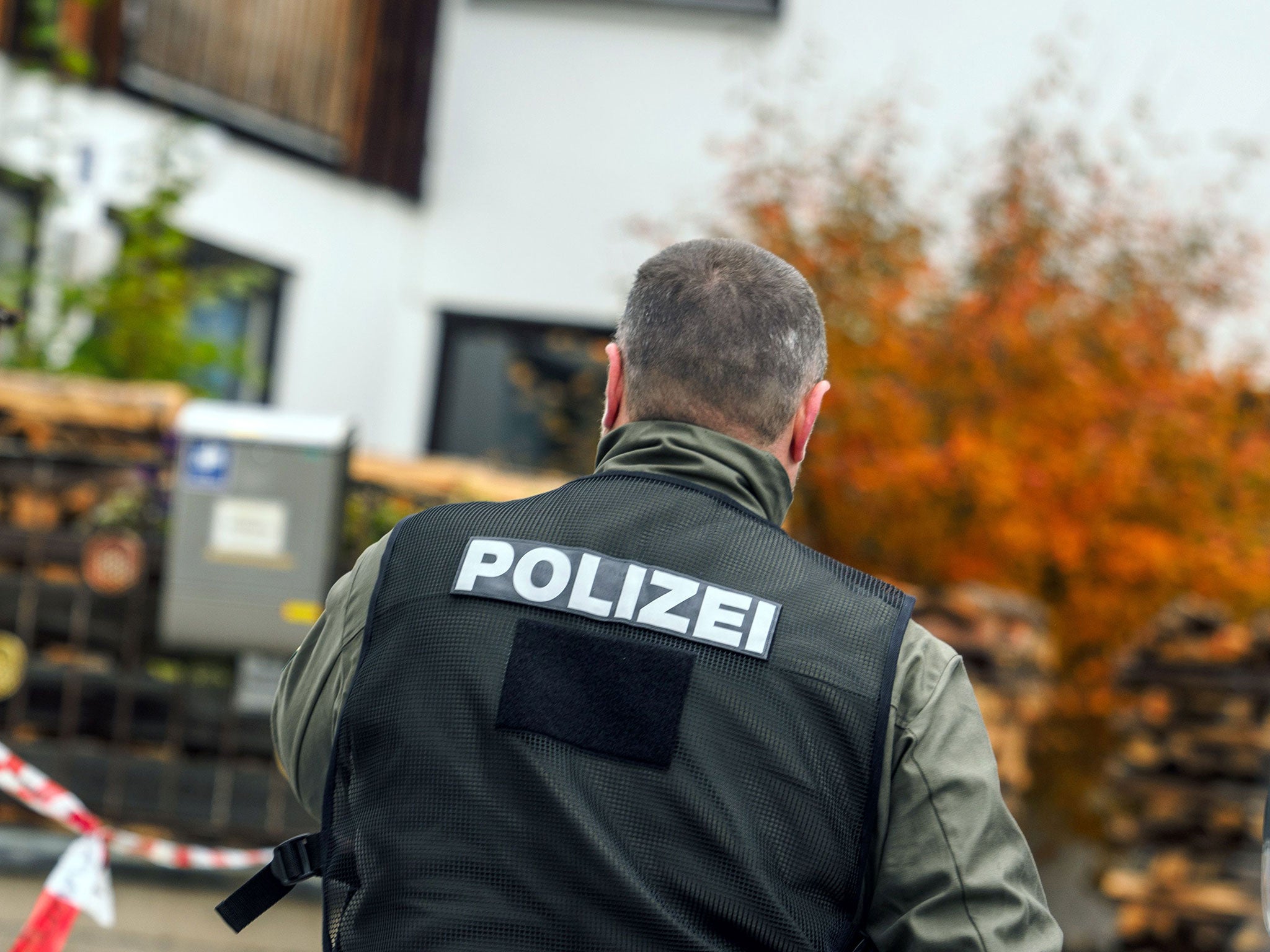 A police officer at a house in Georgensgmünd, Germany, where a far-right extremist opened fire on police during a raid on 19 October