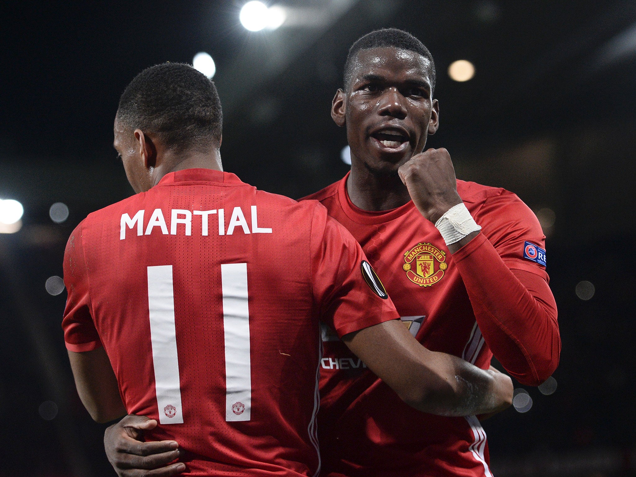 Pogba celebrates his second strike with fellow scorer Martial