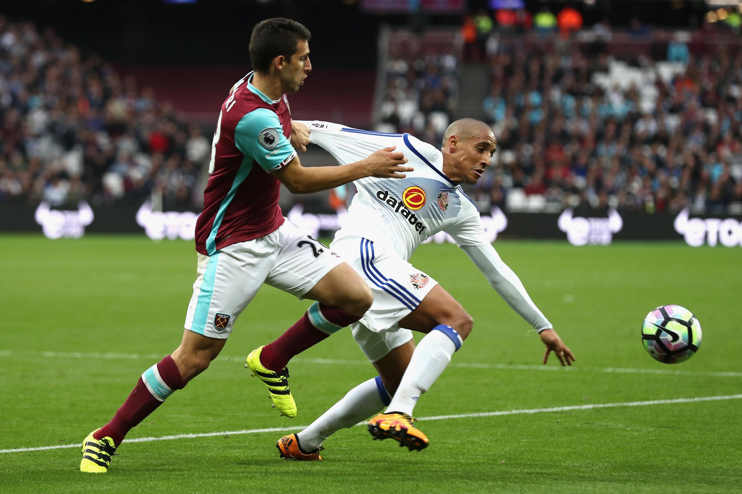 Wahbi Khazri and Jonathan Calleri tussle for the ball