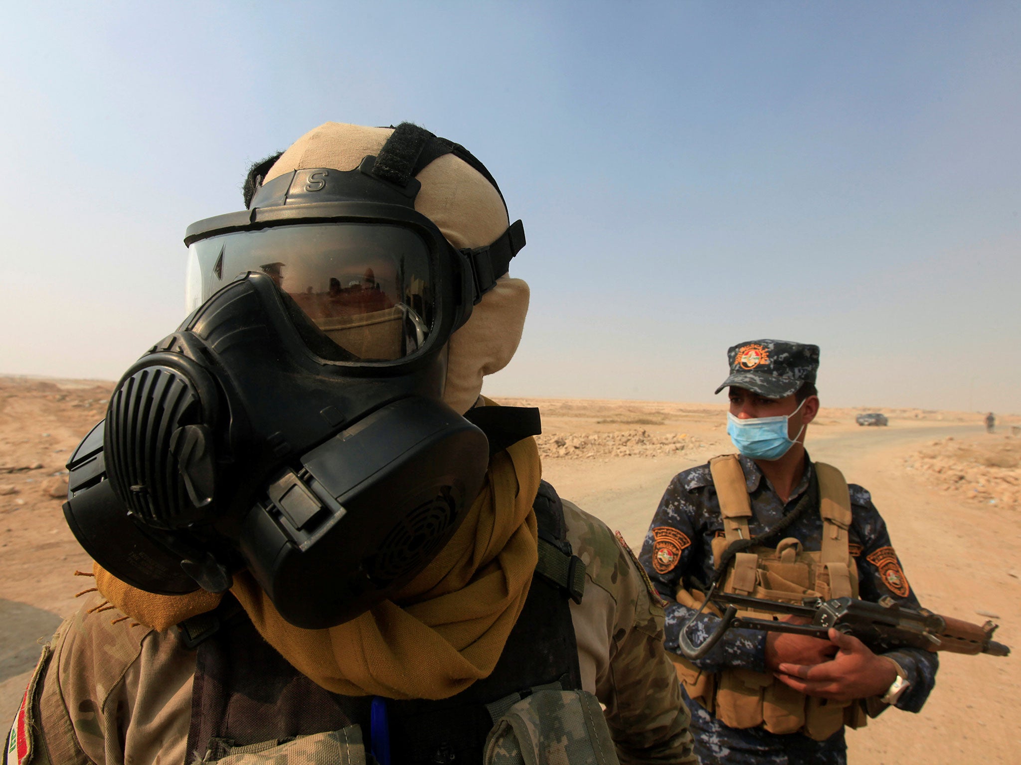 Iraqi forces after a plant was set on fire by retreating Isis fighters near Mosul