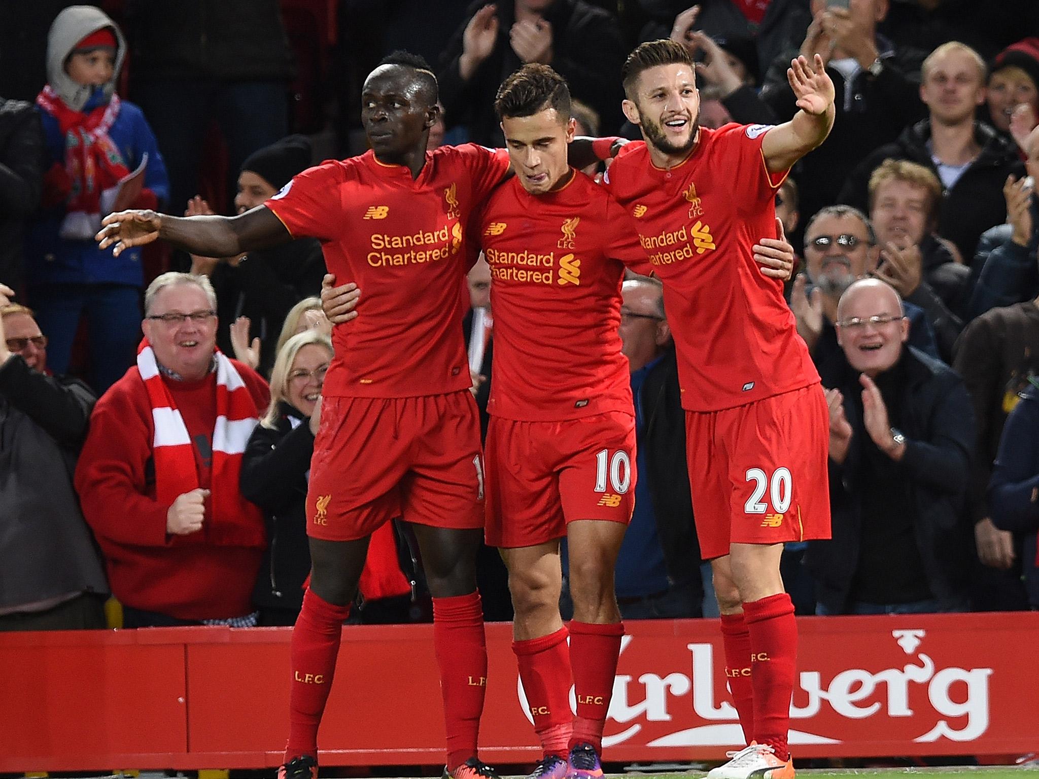 Sadio mane, Philippe Coutinho and Adam Lallana celebrate after the Brazilian scored Liverpool's second