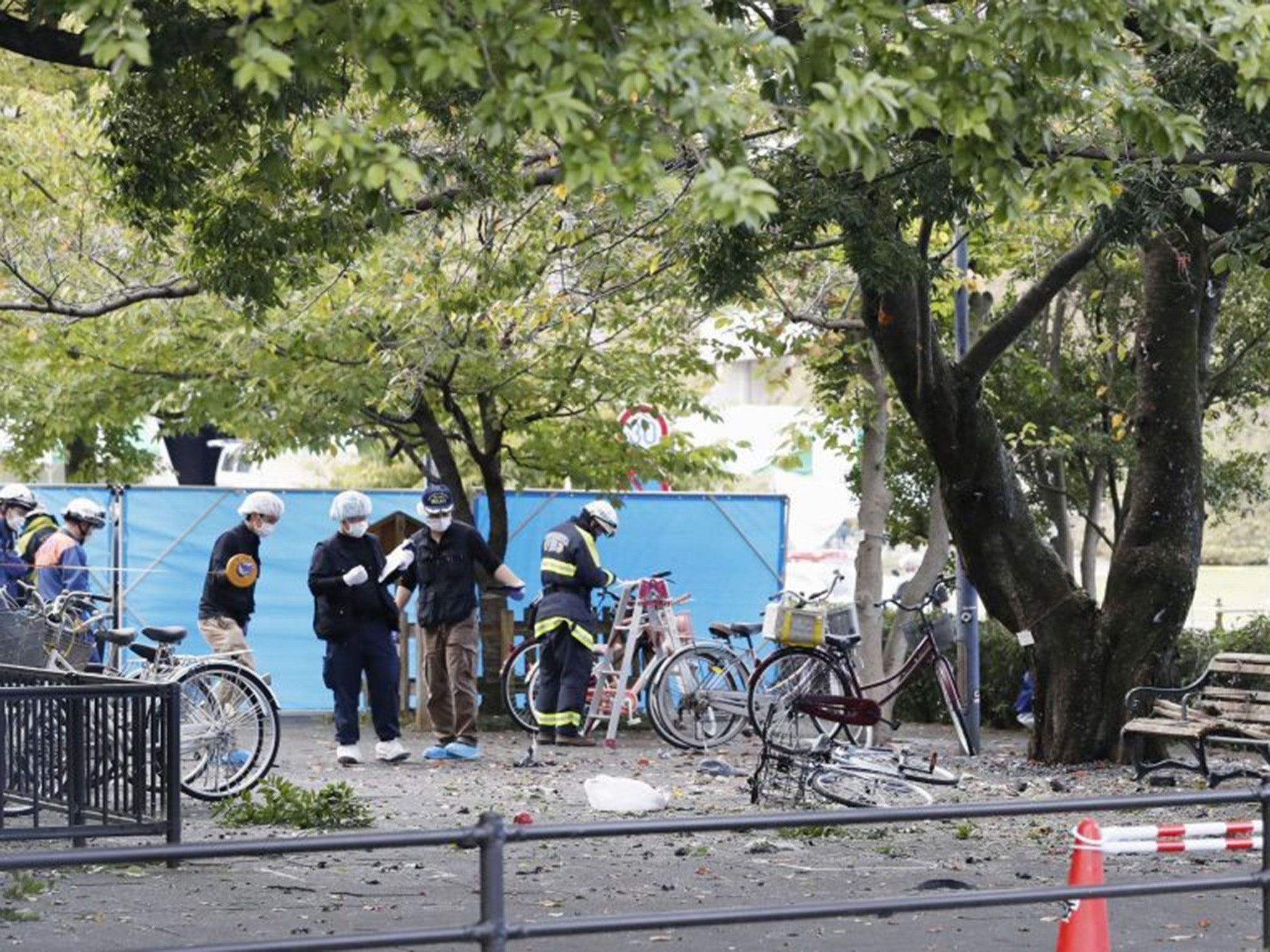 Police inspect the scene of the blast in the car park