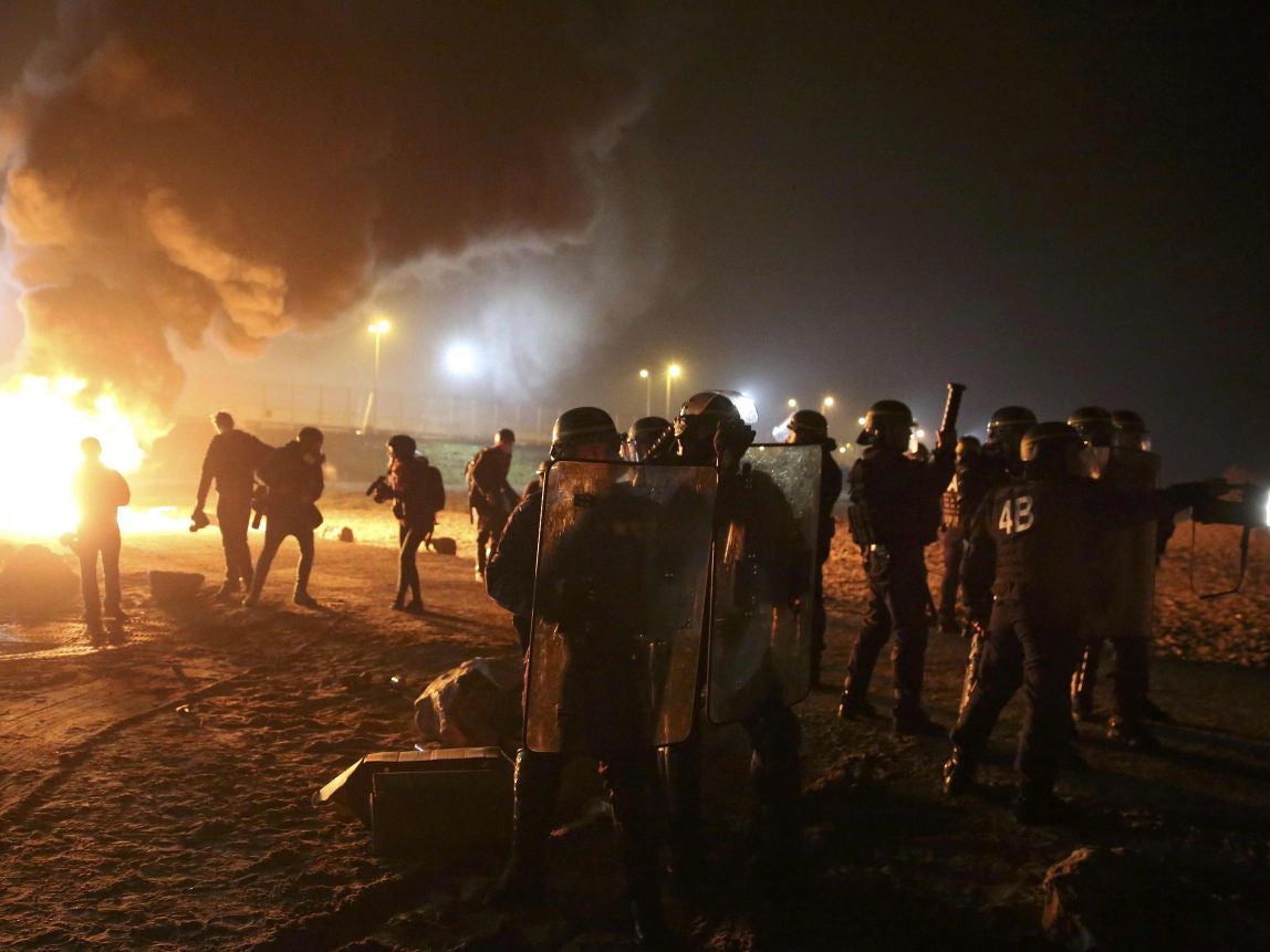 French CRS riot police secure an area on the eve of the evacuation and transfer of migrants to reception centers in France, and the dismantlement of the camp called the "Jungle" in Calais, France