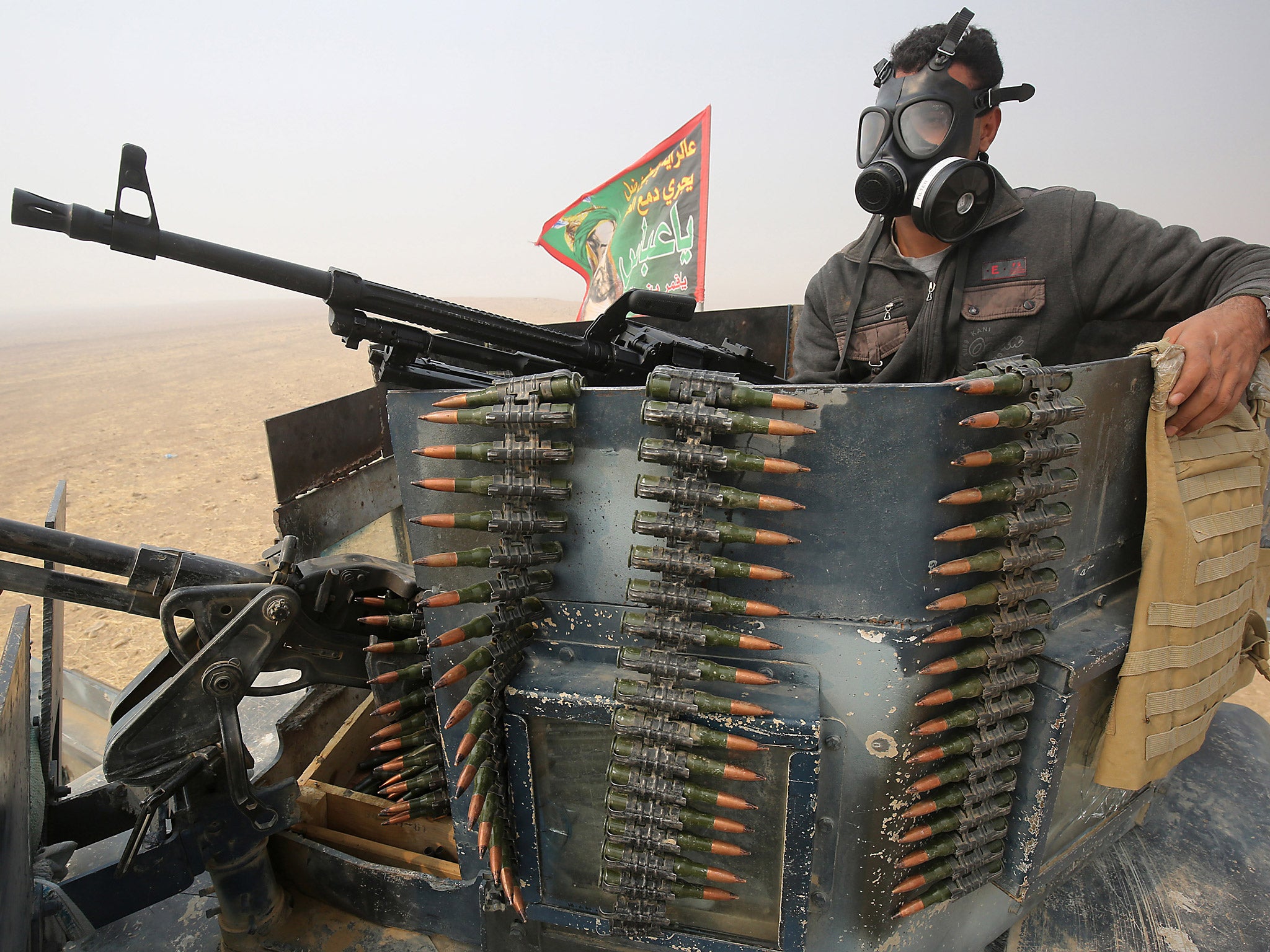 A member of the Iraqi forces holds a position at the al-Shura area, south of Mosul