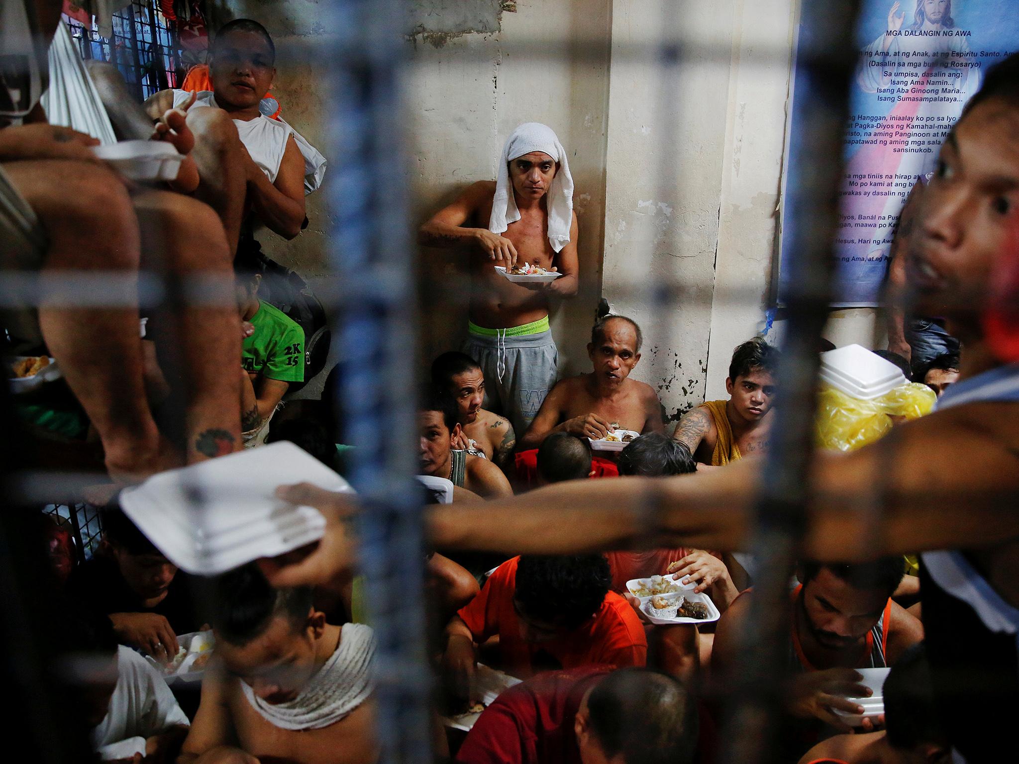 People at a detention cell in a police station in Manila