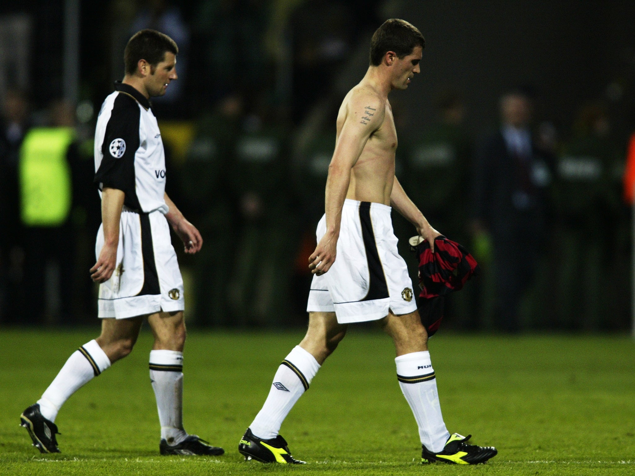 Denis Irwin and Roy Keane trudge off the pitch after United's semi-final defeat to Leverkusen in 2002