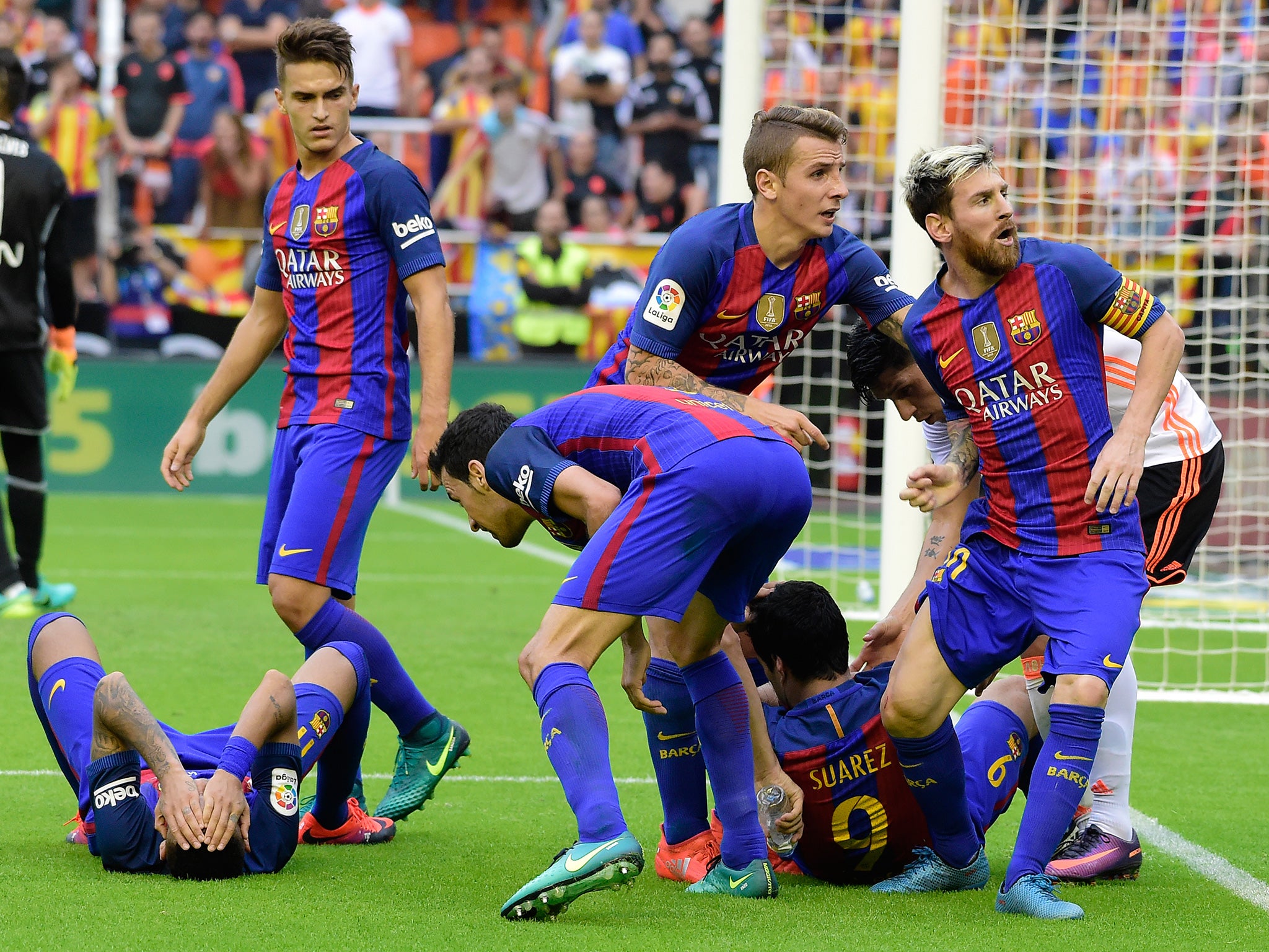 Messi reacts as Neymar and Suarez lie stricken on the pitch