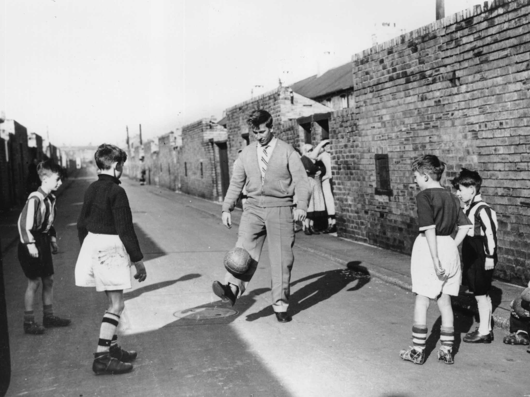 19th February 1958: Bobby Charlton training with some young fans in the backyard of his home on Beatrice Street, Ashington, Northumberland