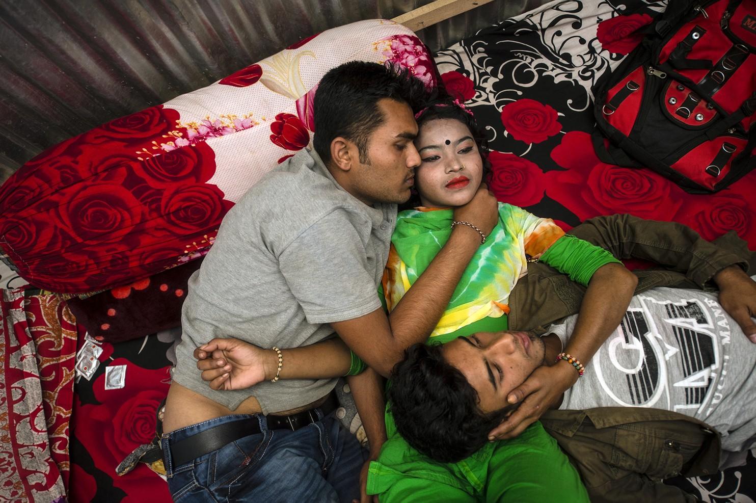 Papia with two customers on a bed