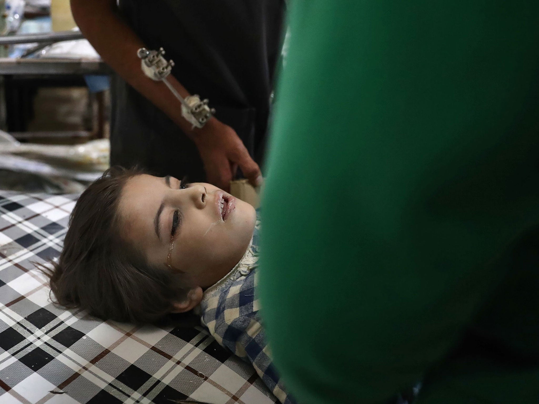 &#13;
A wounded Syrian girl cries as she receives treatment at a makeshift hospital following government shelling on the rebel-held town of Douma on 27 October (AFP/Getty)&#13;