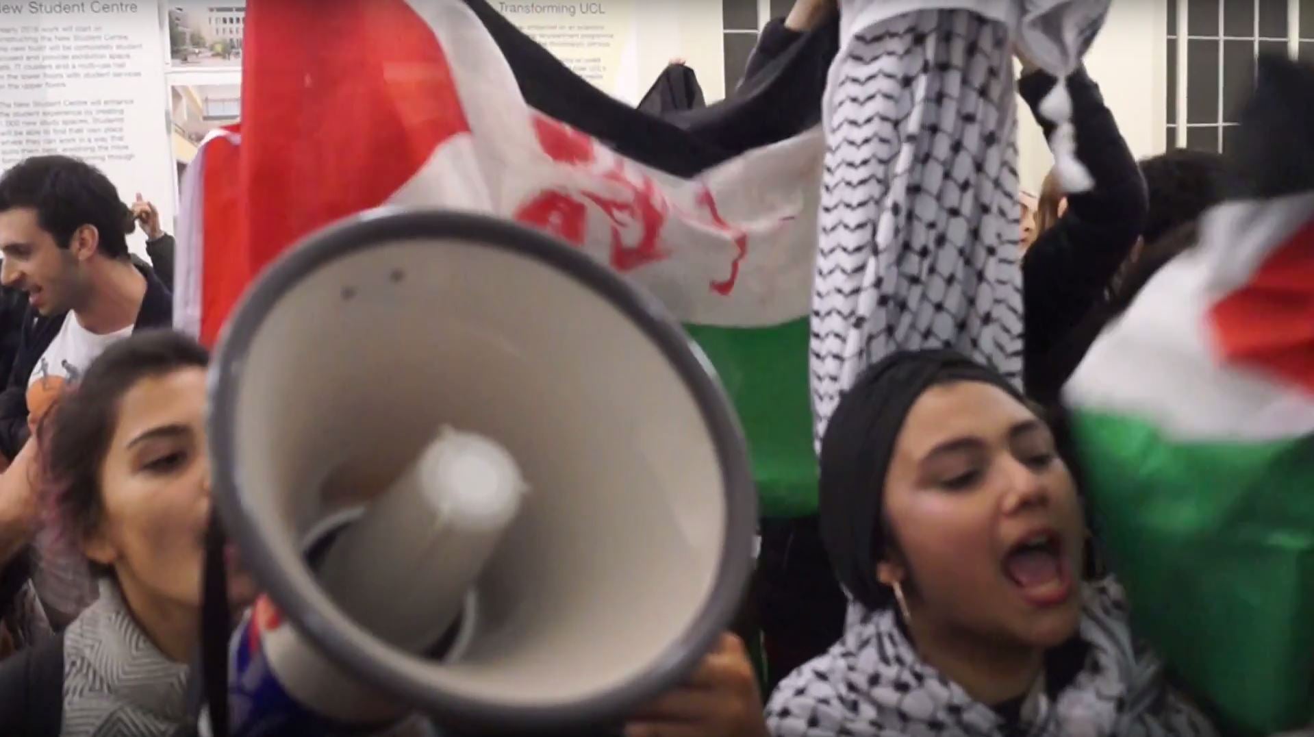 Students with banners arrive at the UCL talk, shouting anti-Israeli chants