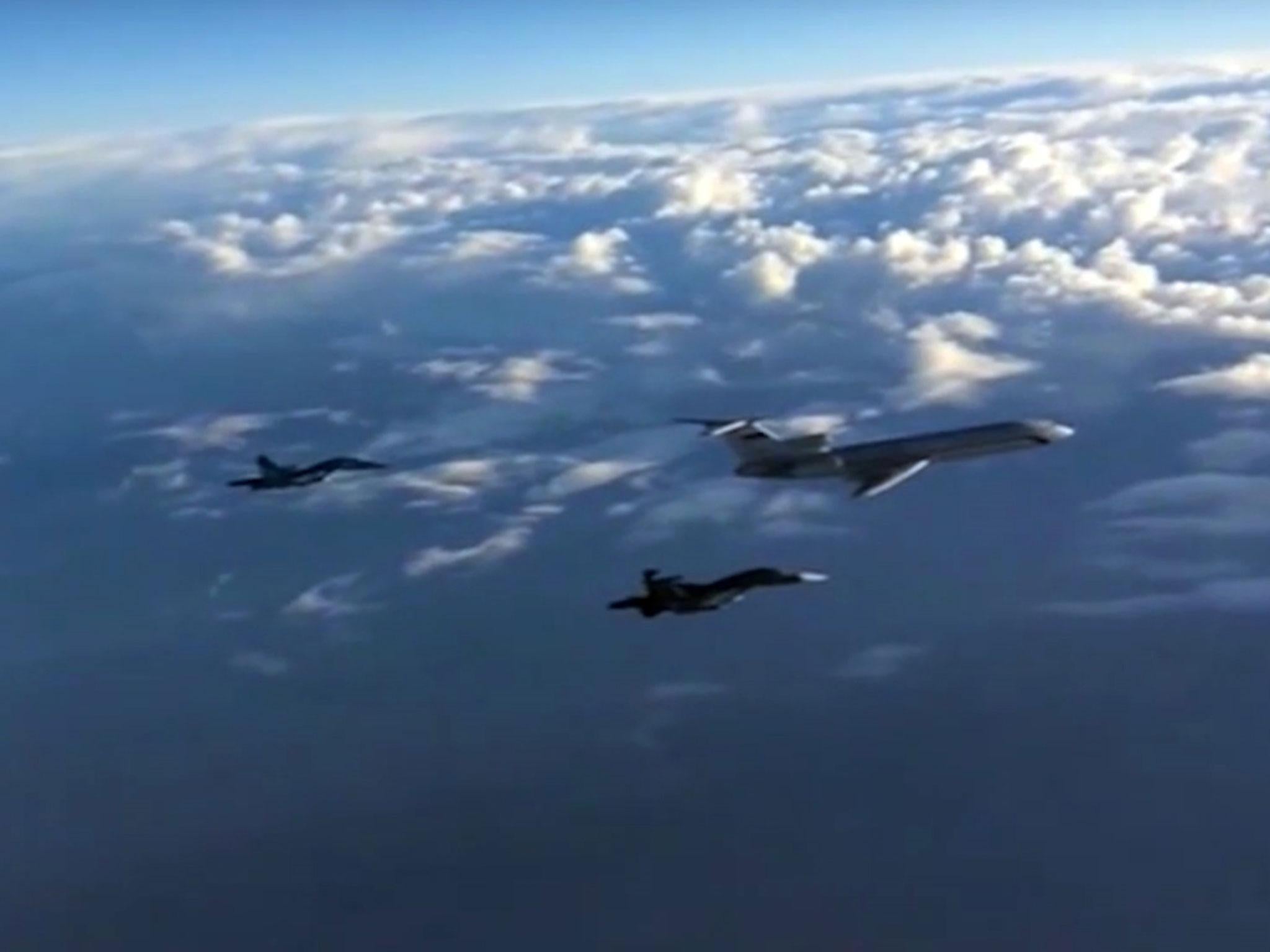 An image taken from a footage made available on the Russian Defence Ministry's official website on 15 March, 2016, reportedly showing Russian Su-34 bombers and a Tupolev Tu-154 transport plane flying above an unknown location on their way from the Hmeimim airbase in Syria to their permanent bases in the Russian Federation