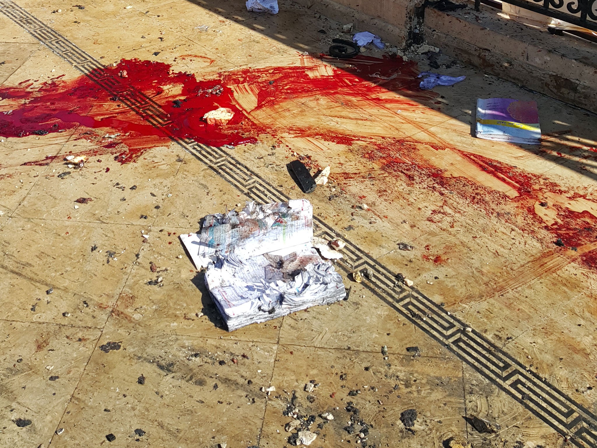 The bloody balcony outside the schoolroom where three children were killed by a shell fired from eastern Aleppo