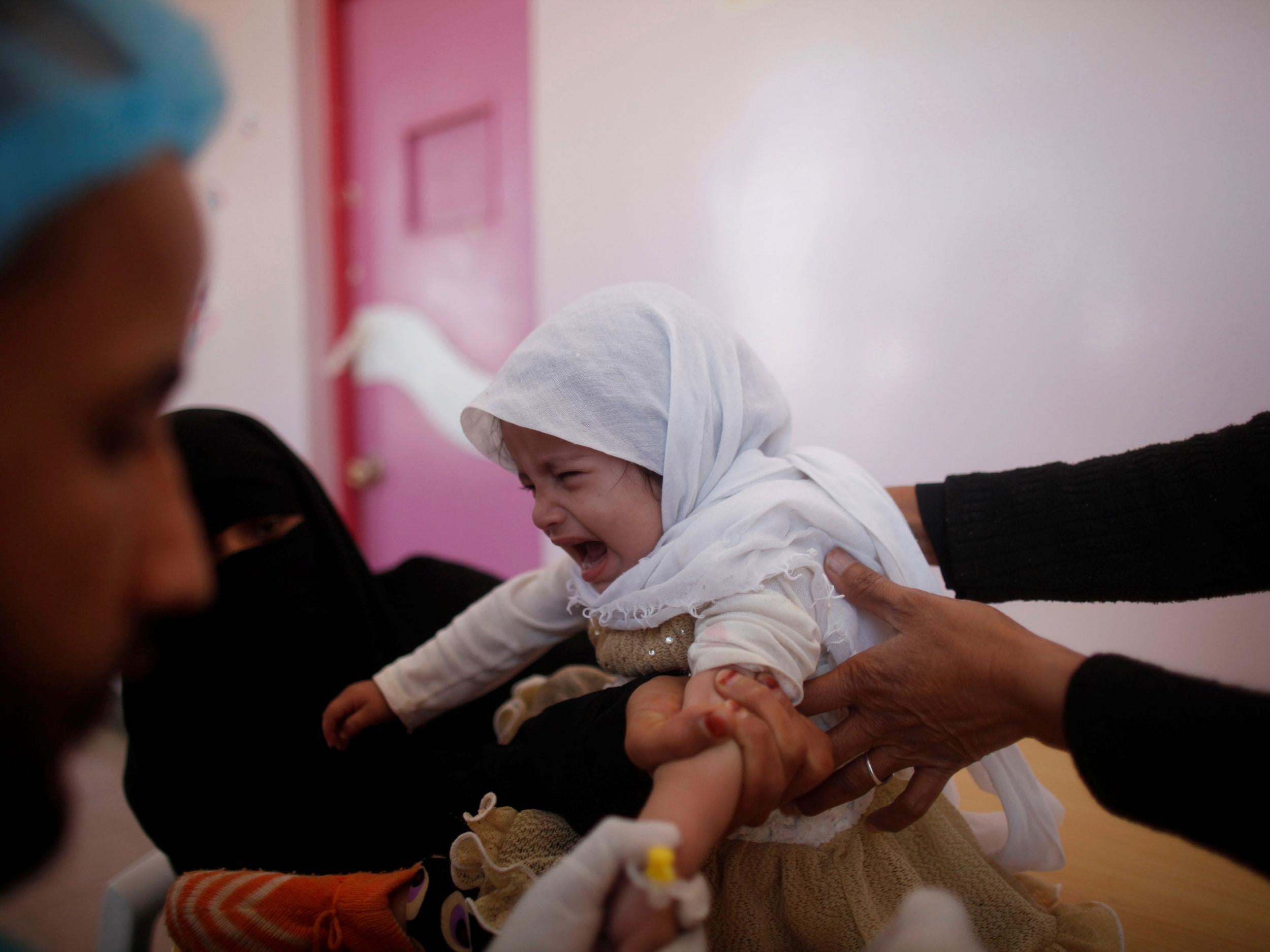 A girl cries as she is treated at a cholera treatment centre in Sanaa