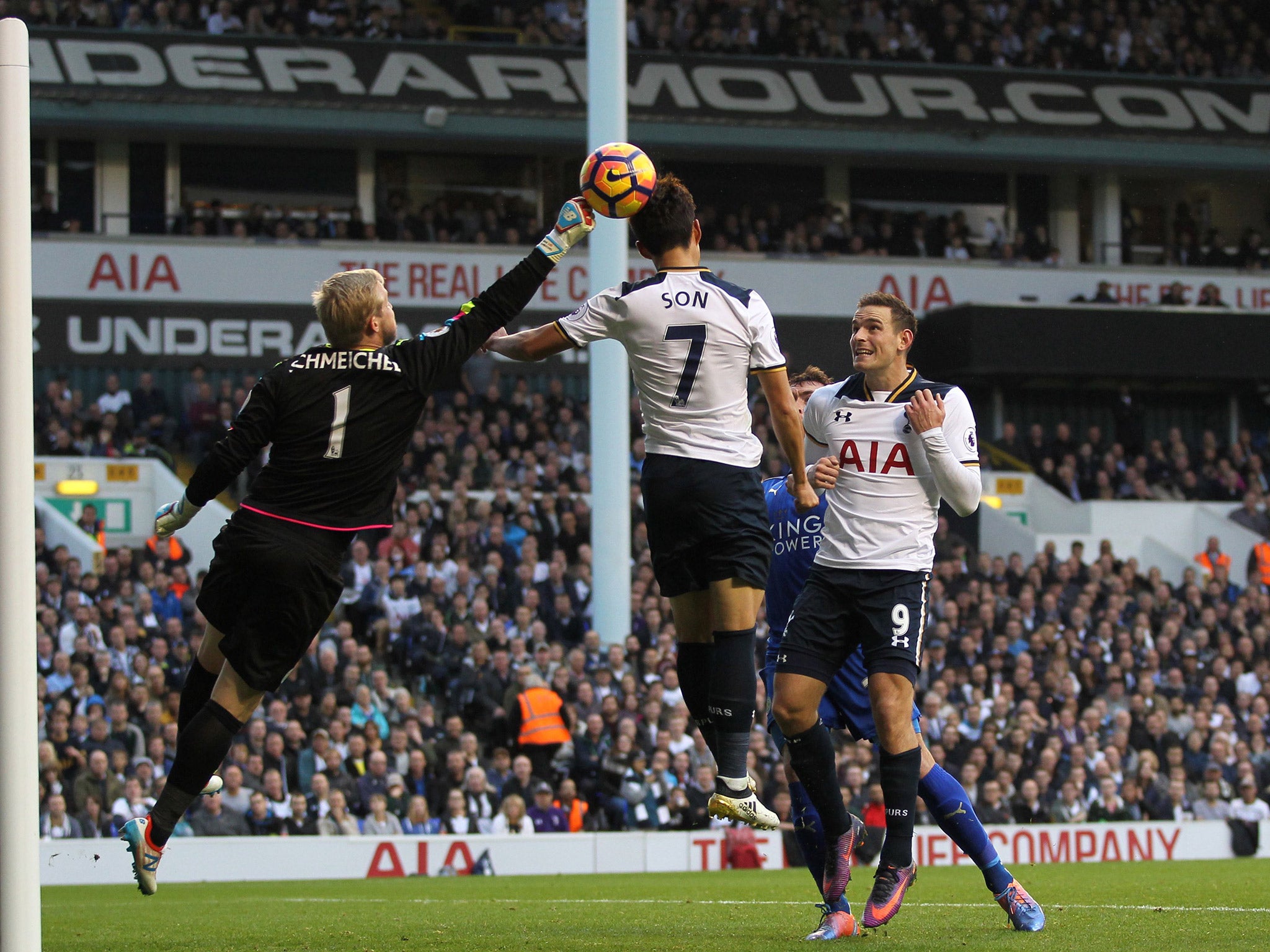 Kasper Schmeichel punches the ball clear as Son Heung-min leaps for a header