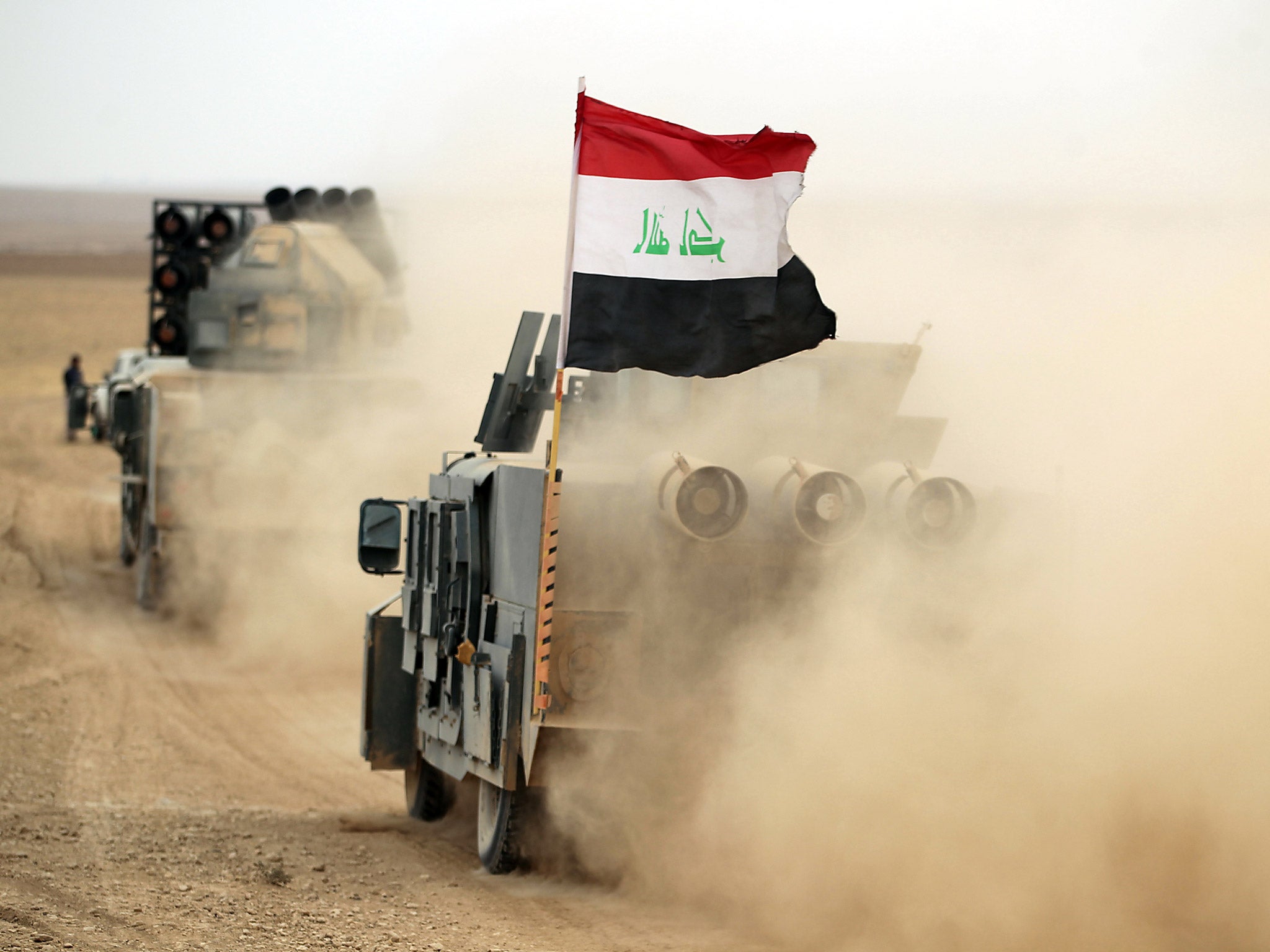 Iraqi forces drive their vehicles in the al-Shura area, south of Mosul