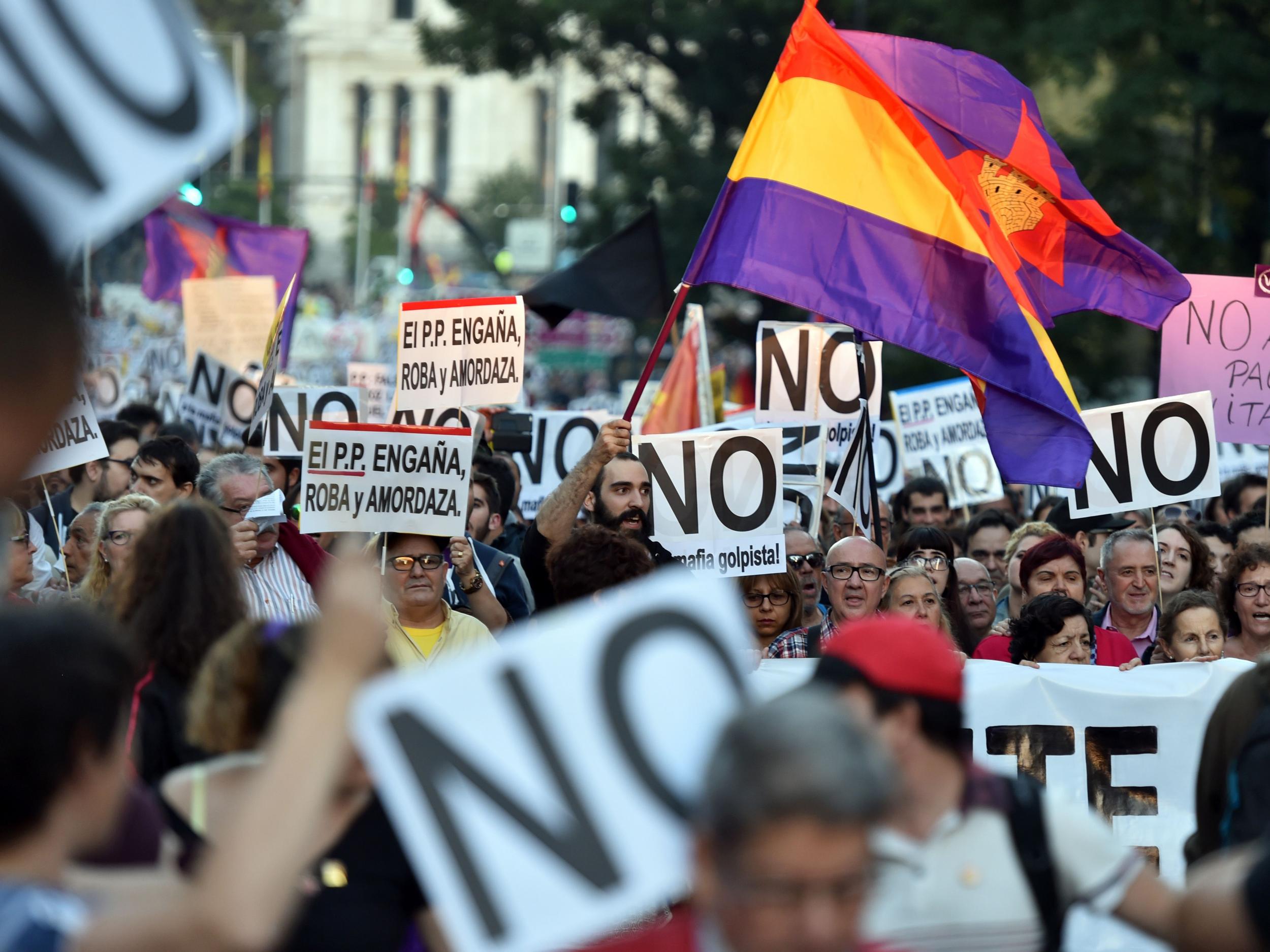 Protesters in Madrid contest Spain's interim Prime Minister Mariano Rajoy's reappointment for a second term