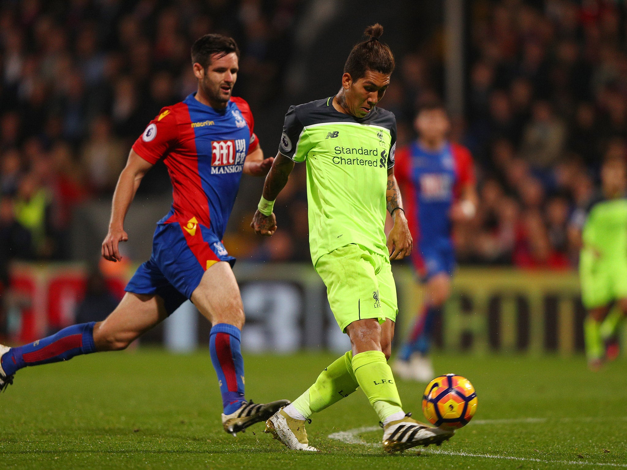 Roberto Firmino chips the ball over Steve Mandanda to score Liverpool's fourth