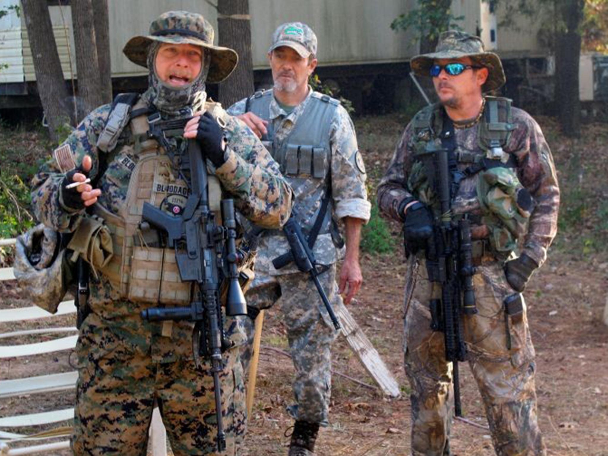 Chris Hill, leader of the Georgia chapter of the III% Security Force, left, who also goes by the name Bloodagent