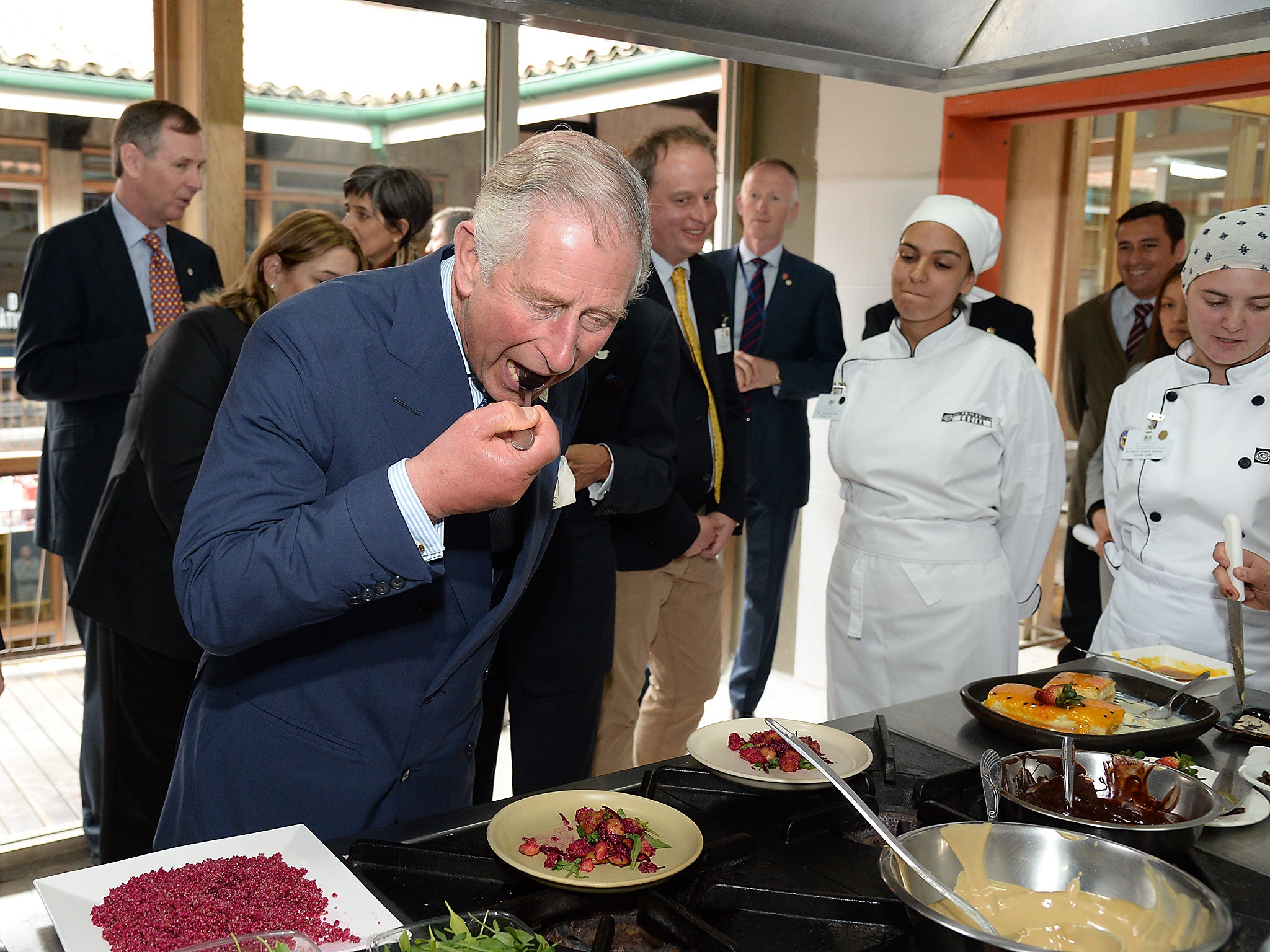 Prince Charles tastes some traditional Colombian food on a visit to Colombia