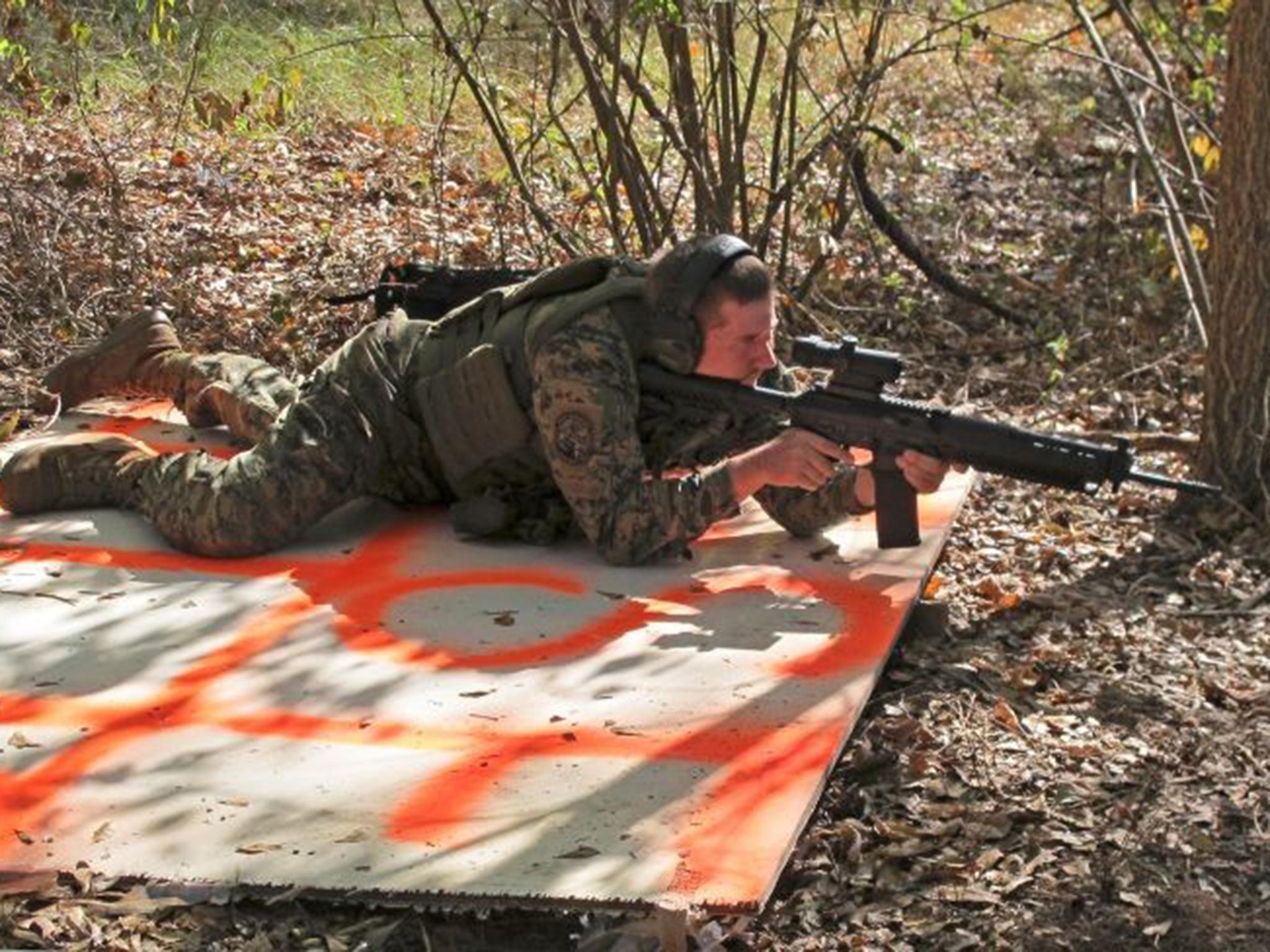 A member of the militia trains in the Georgia woods