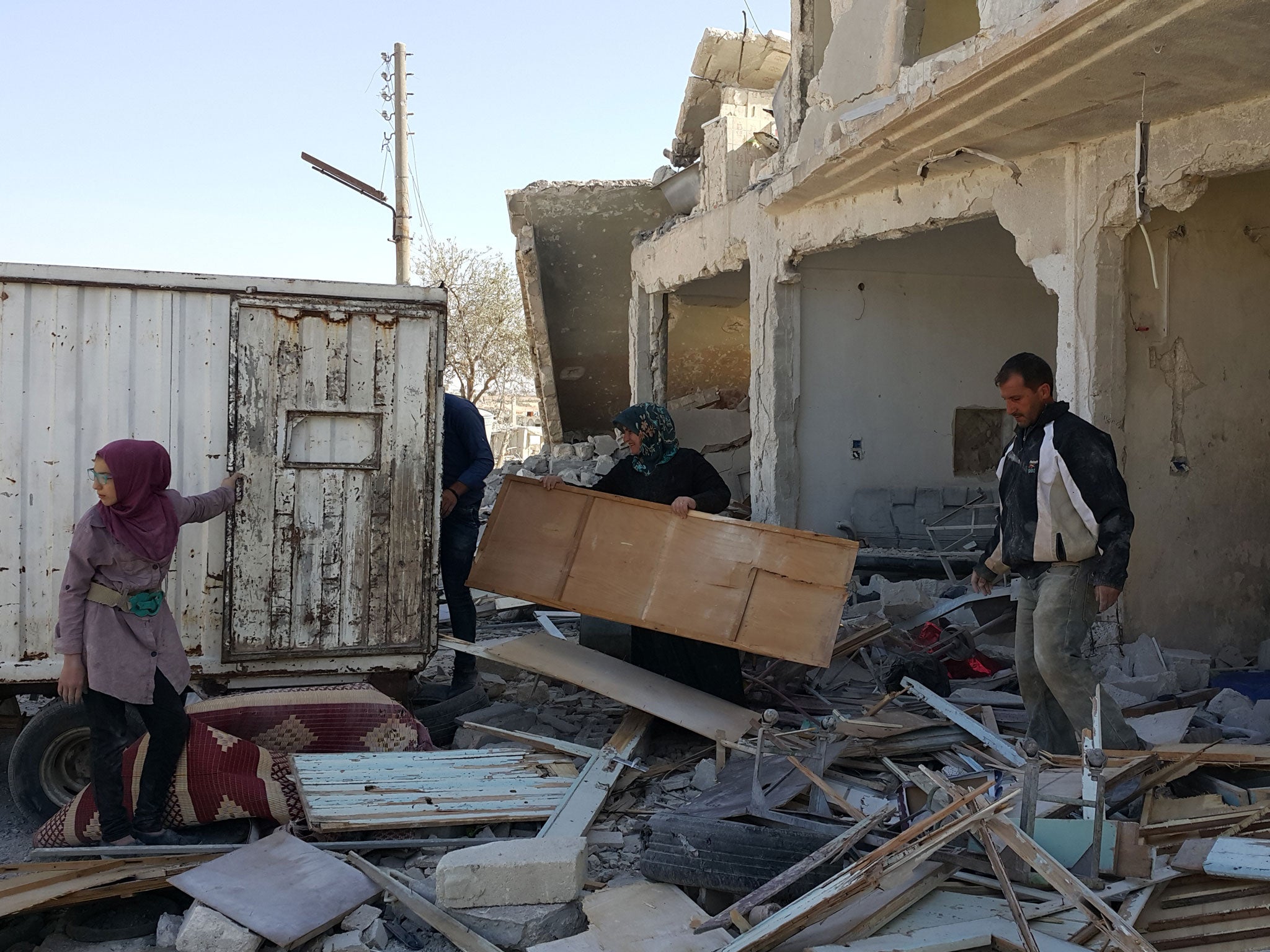 The Hamdo family collect what is left of their home