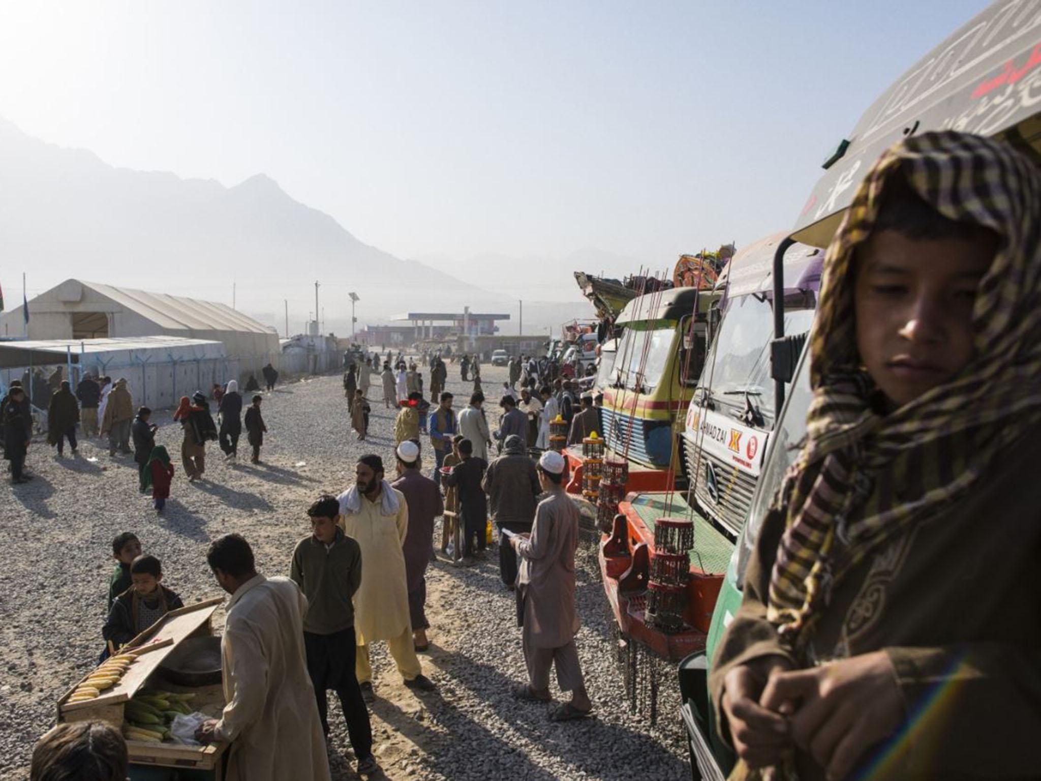 Families wait outside for a UN ‘encashment’ centre to open last month on the outskirts of Kabul. Afghan returnees are provided with health checks, immunisations and needs assessments