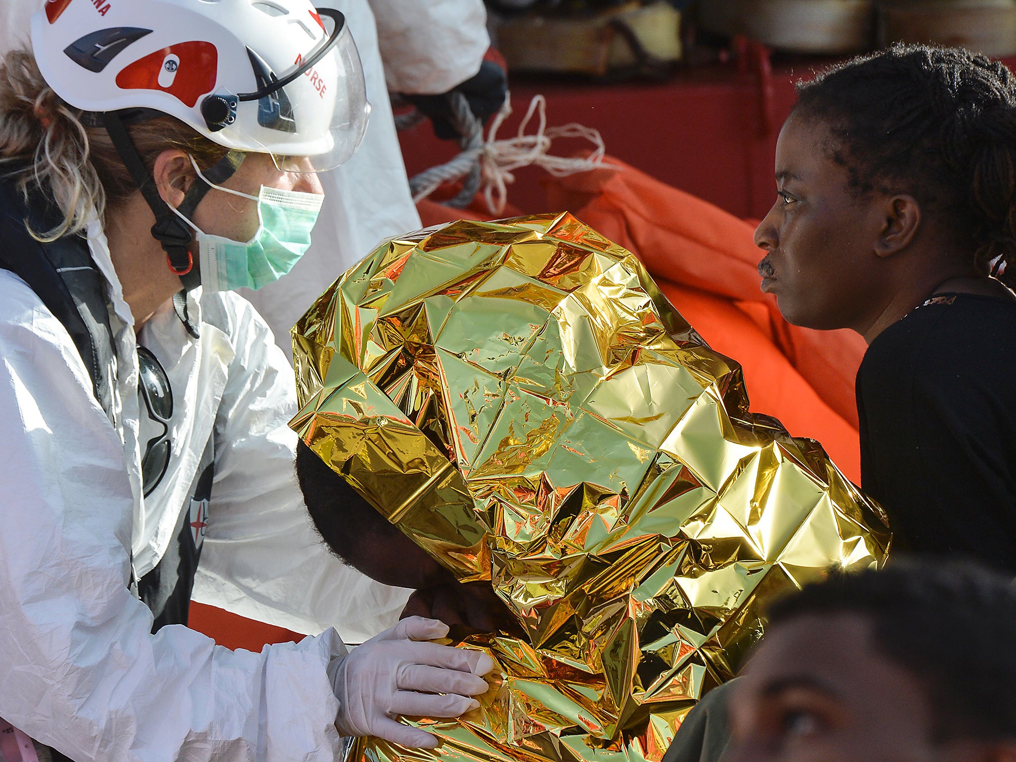 A female doctor speaks with women aboard the Topaz Responder ship run by Maltese NGO Moas and the Italian Red Cross during a rescue operation of migrants and refugees