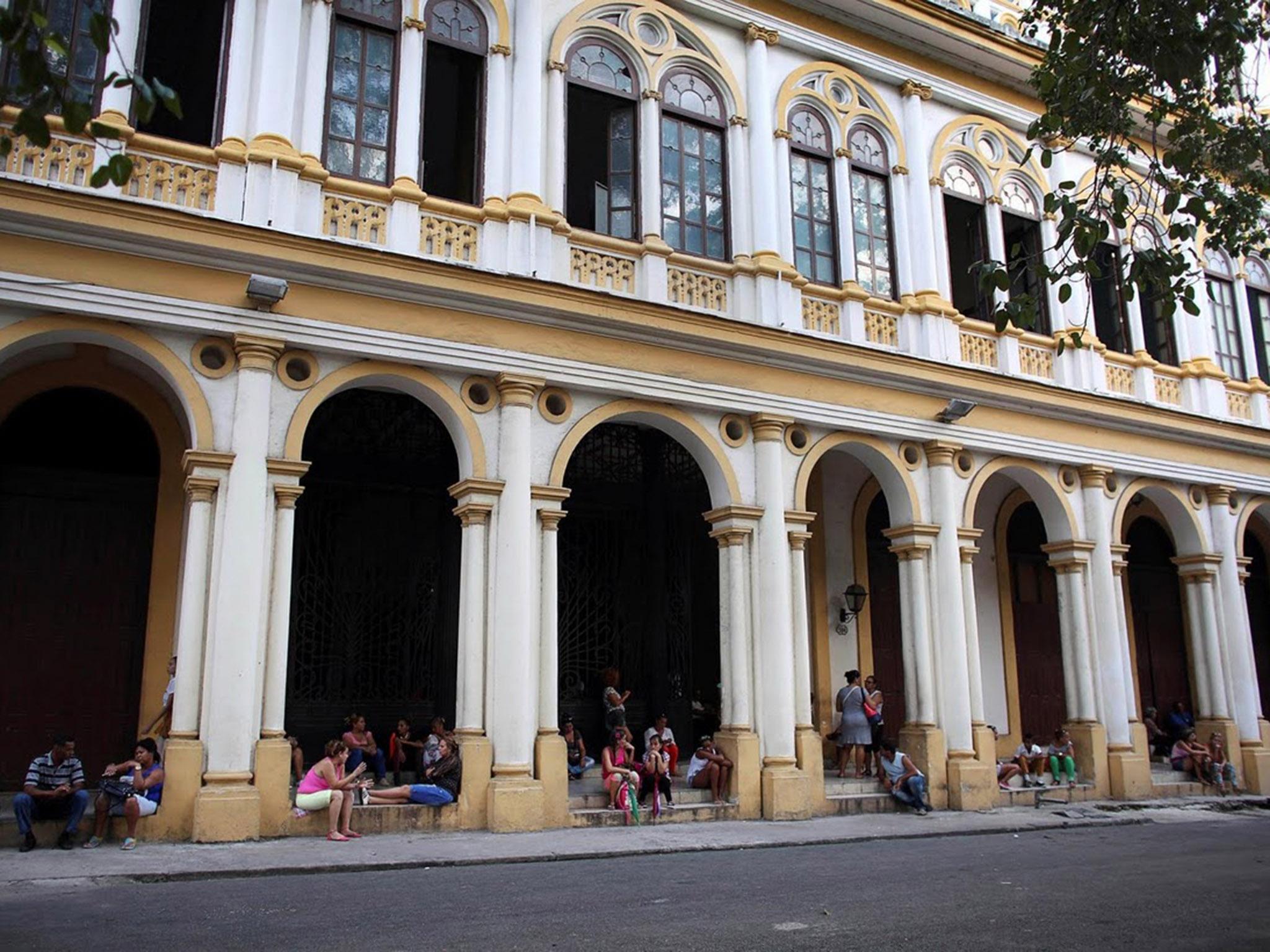 Relatives of students wait for the end of the lessons outside the Cuba's National Ballet School (ENB) in Havana, Cuba