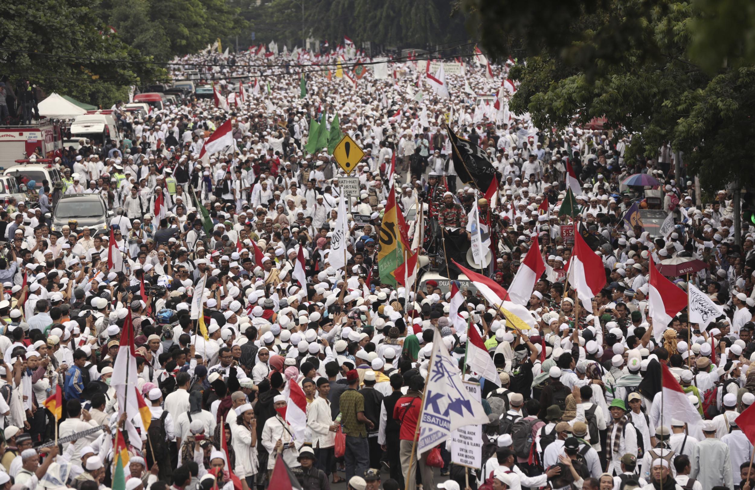 Muslim protesters march during a demonstration in Jakarta to demand the arrest of its minority-Christian governor for alleged blasphemy