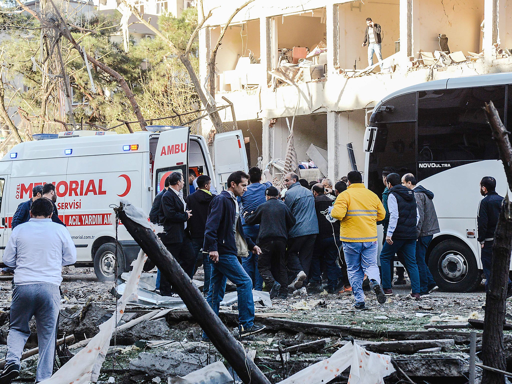 Turkish rescue officials and people carry an injured man to an ambulance following a separate explosion in Diyarbakir (file photo)