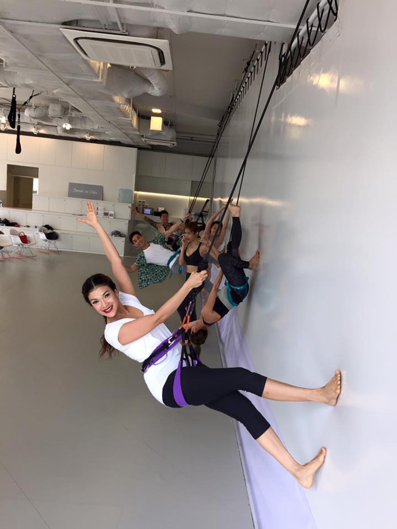 People are strapped to resistant bungee ropes that are suspended from the ceiling