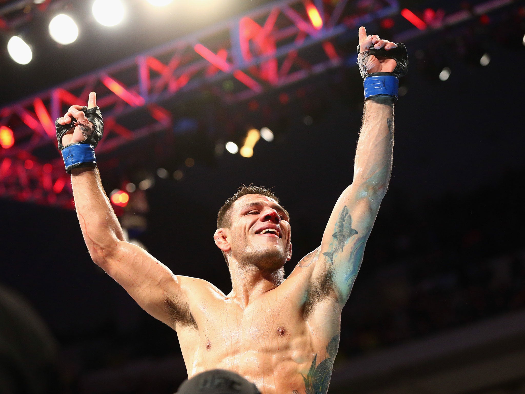 Rafael dos Anjos celebrates his win against Anthony Pettis in the Lightweight Title bout during the UFC 185