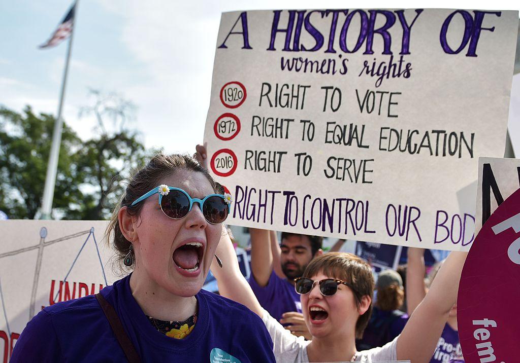 Abortion rights activists cheer after the US Supreme Court struck down a Texas law placing restrictions on abortion clinics