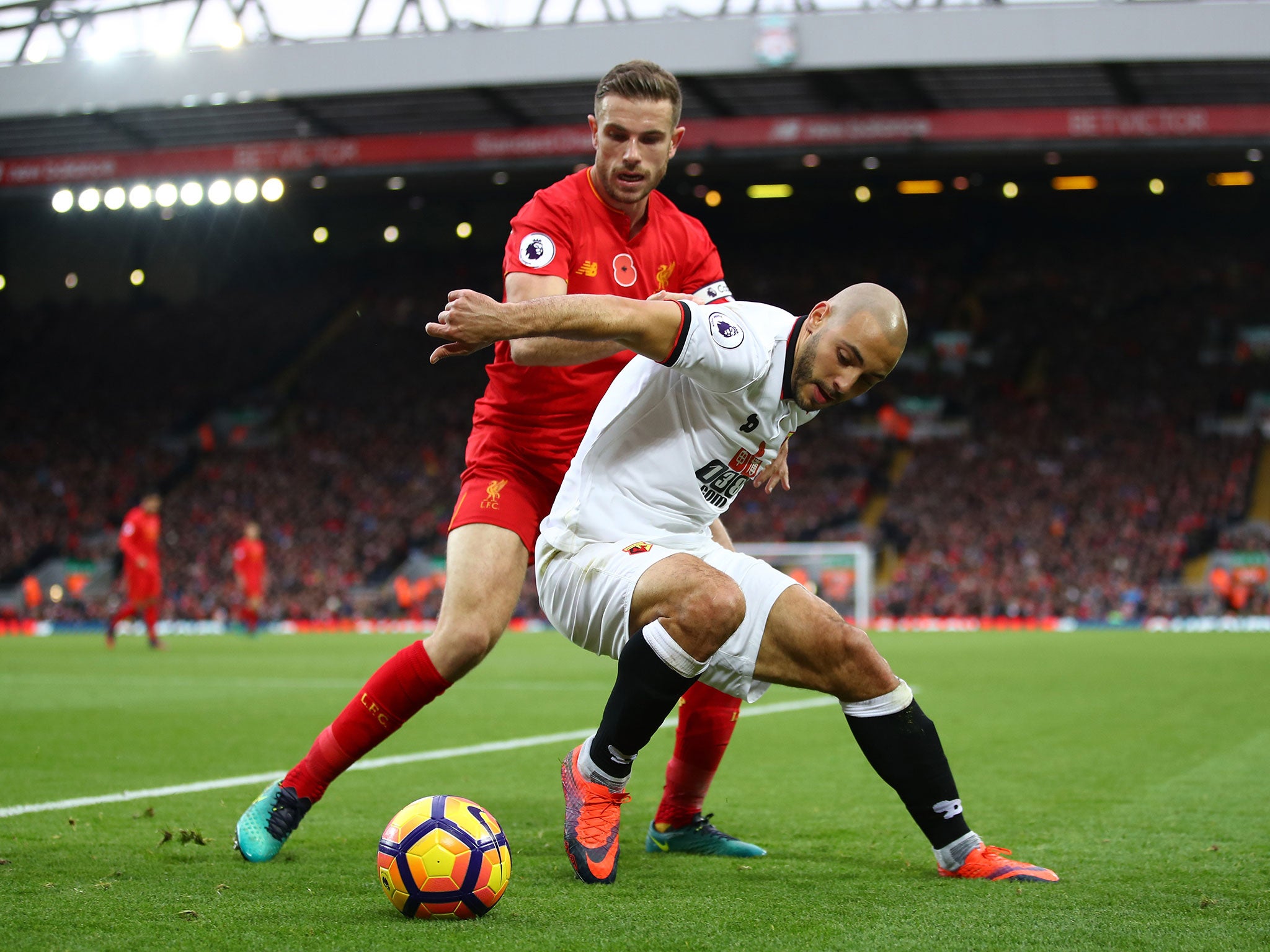 Jordan Henderson and Nordin Amrabat tussle for the ball