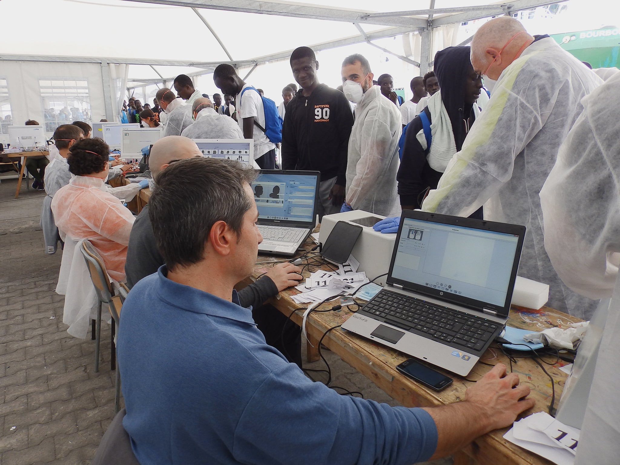 Refugees and migrants being fingerprinted after disembarking from MSF rescue ship the Bourbon Argos in Catania, Sicily