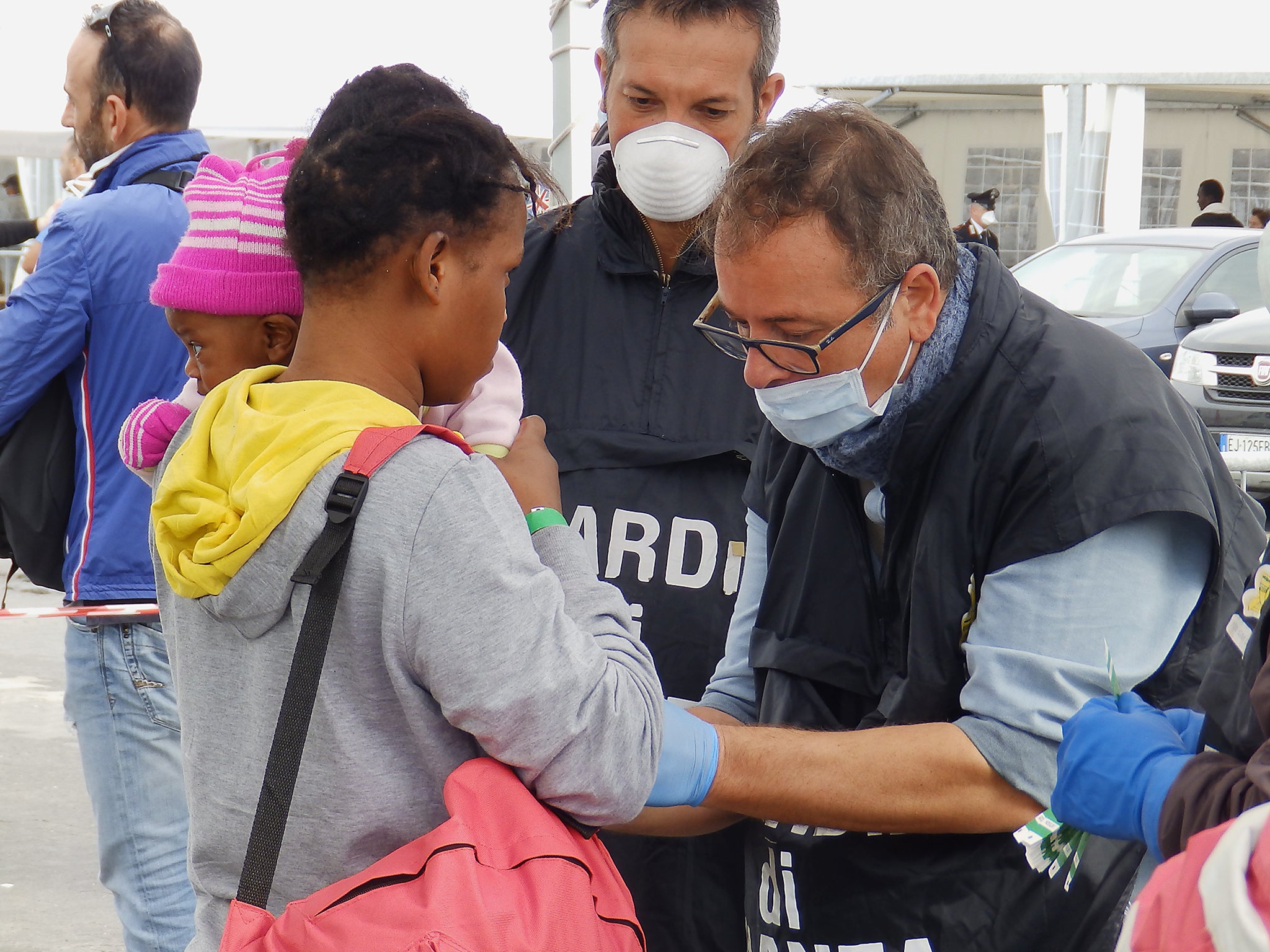 Refugees and migrants undergoing security checks after disembarking from MSF rescue ship the Bourbon Argos in Catania, Sicily