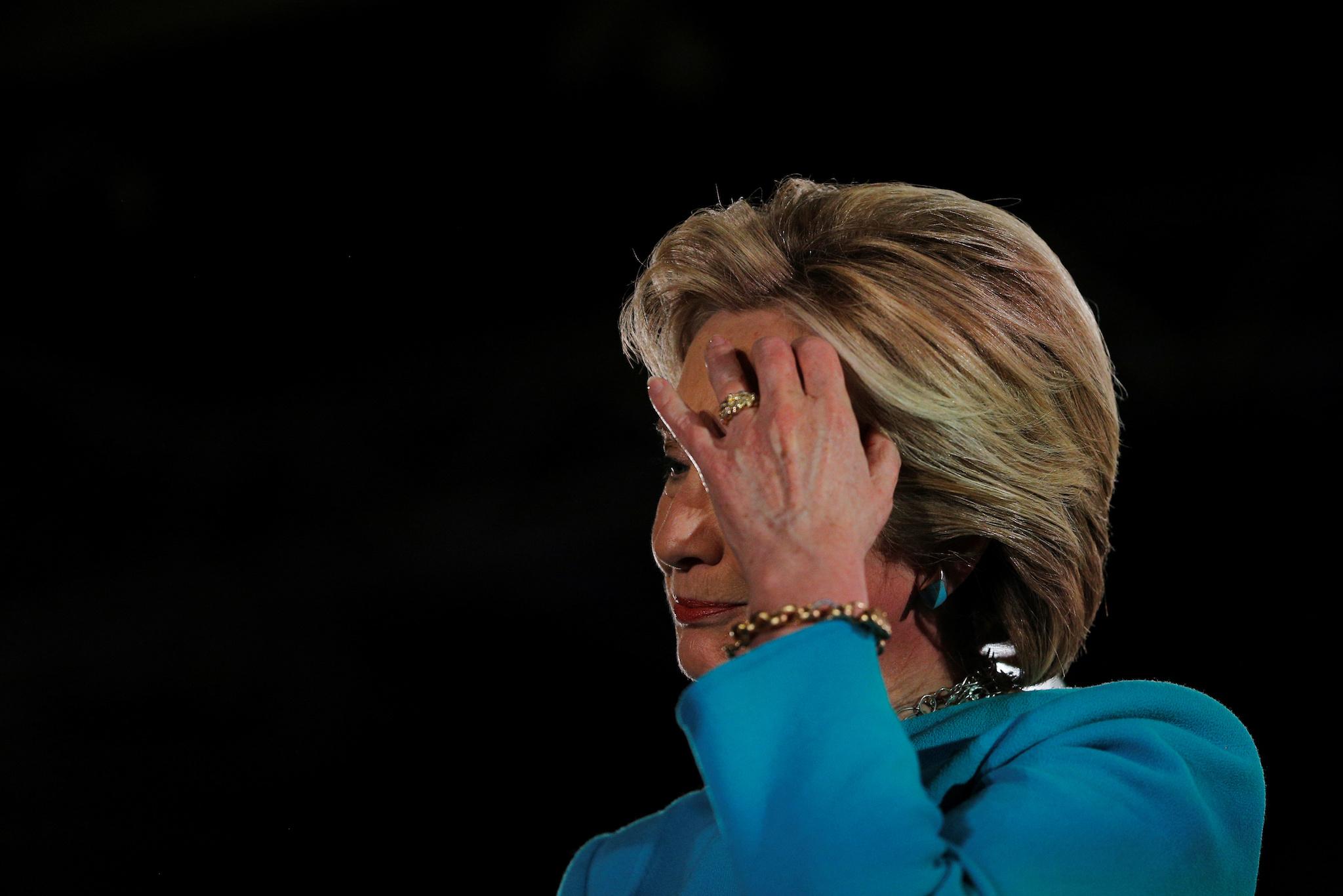 U.S. Democratic presidential nominee Hillary Clinton listens as she is introduced by Gold Star father Khizr Khan at a campaign rally in Manchester, New Hampshire, U.S. November 6, 2016