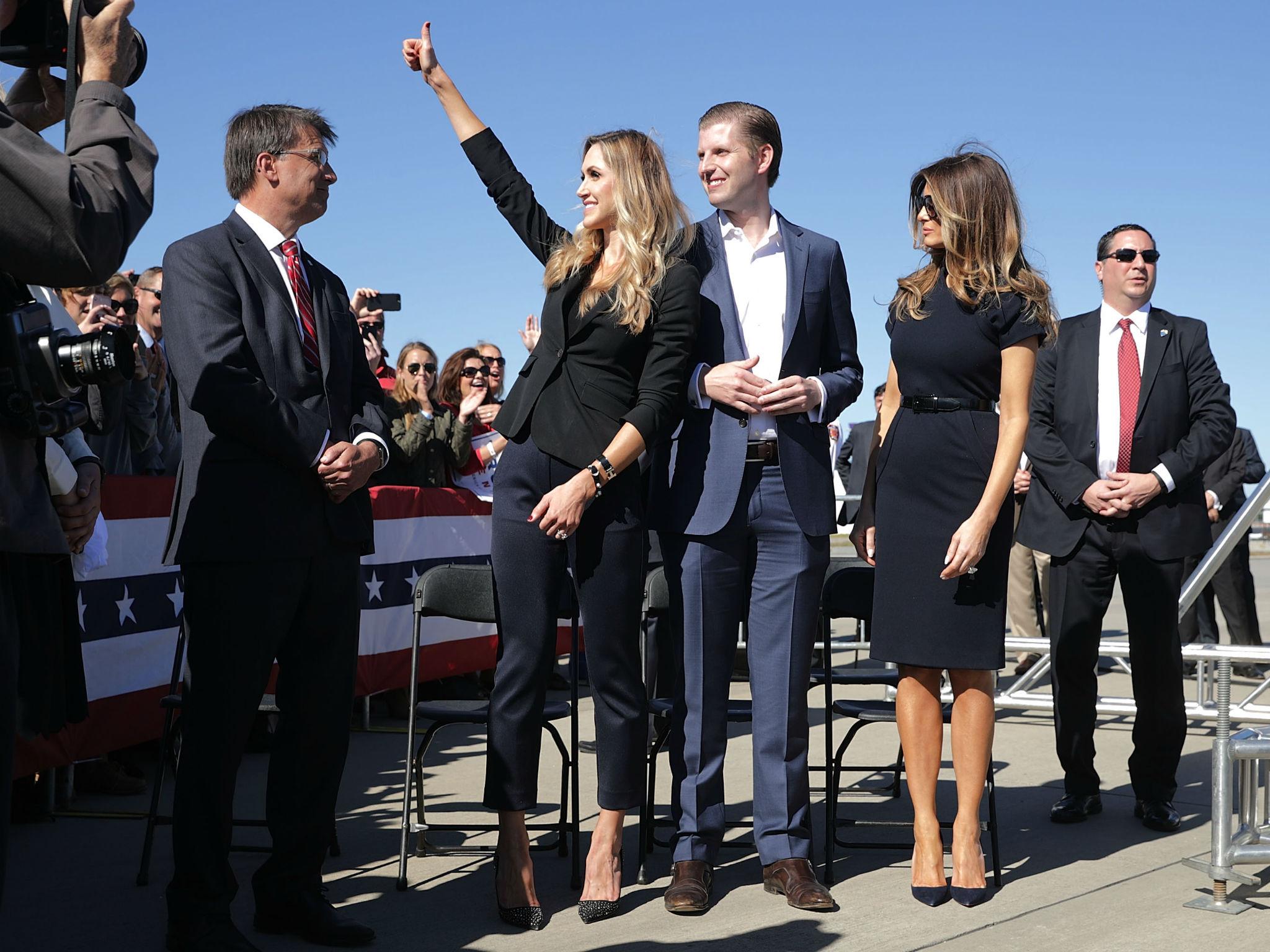 Lara Trump, left, beside Eric and Melania Trump