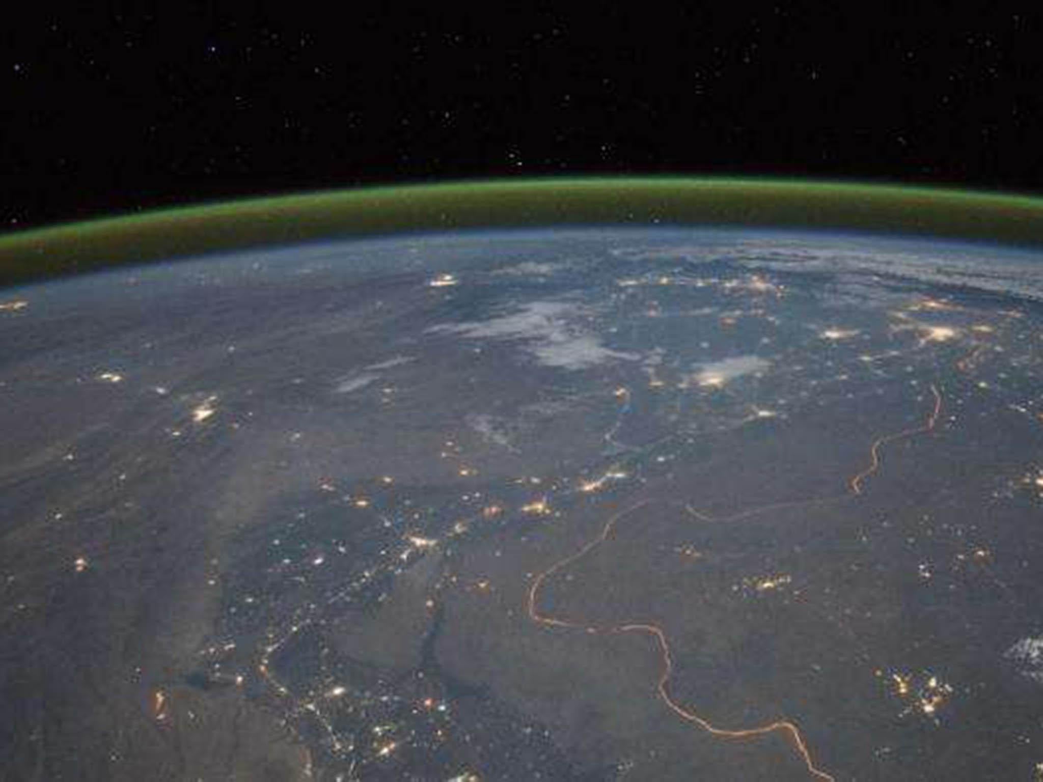 Nighttime panorama showing Pakistan’s Indus River valley, taken from space. The green band above the horizon is airglow