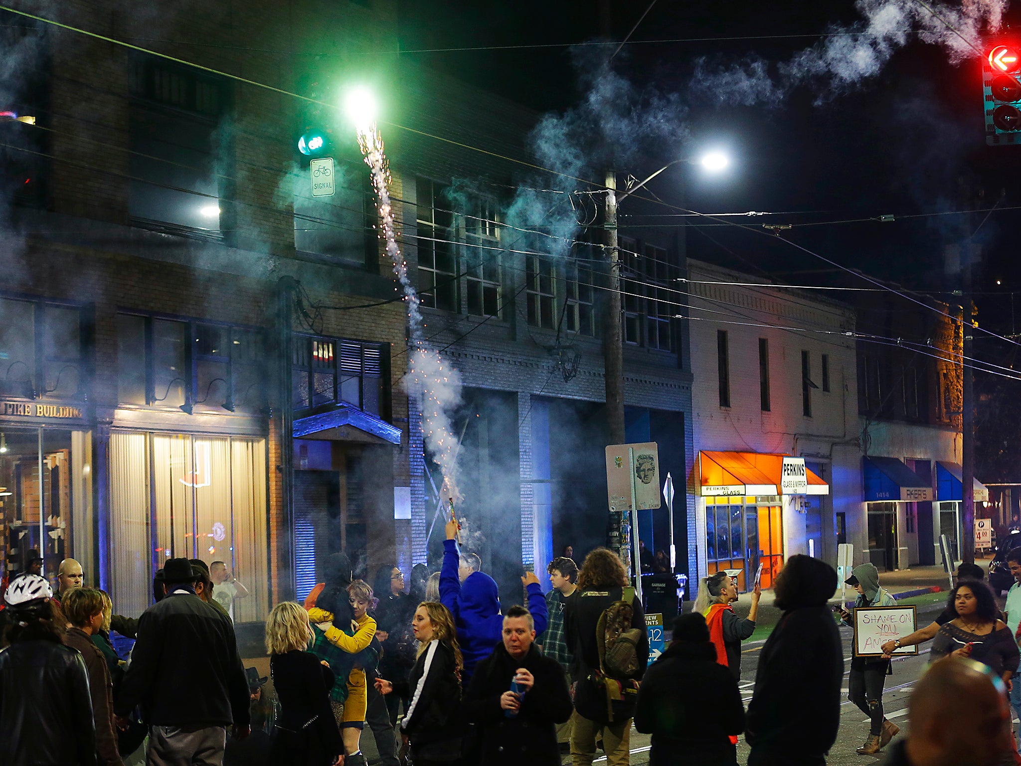 A protester sets off fireworks during a protest against President-elect Donald Trump in Seattle’s Capitol Hill neighborhood